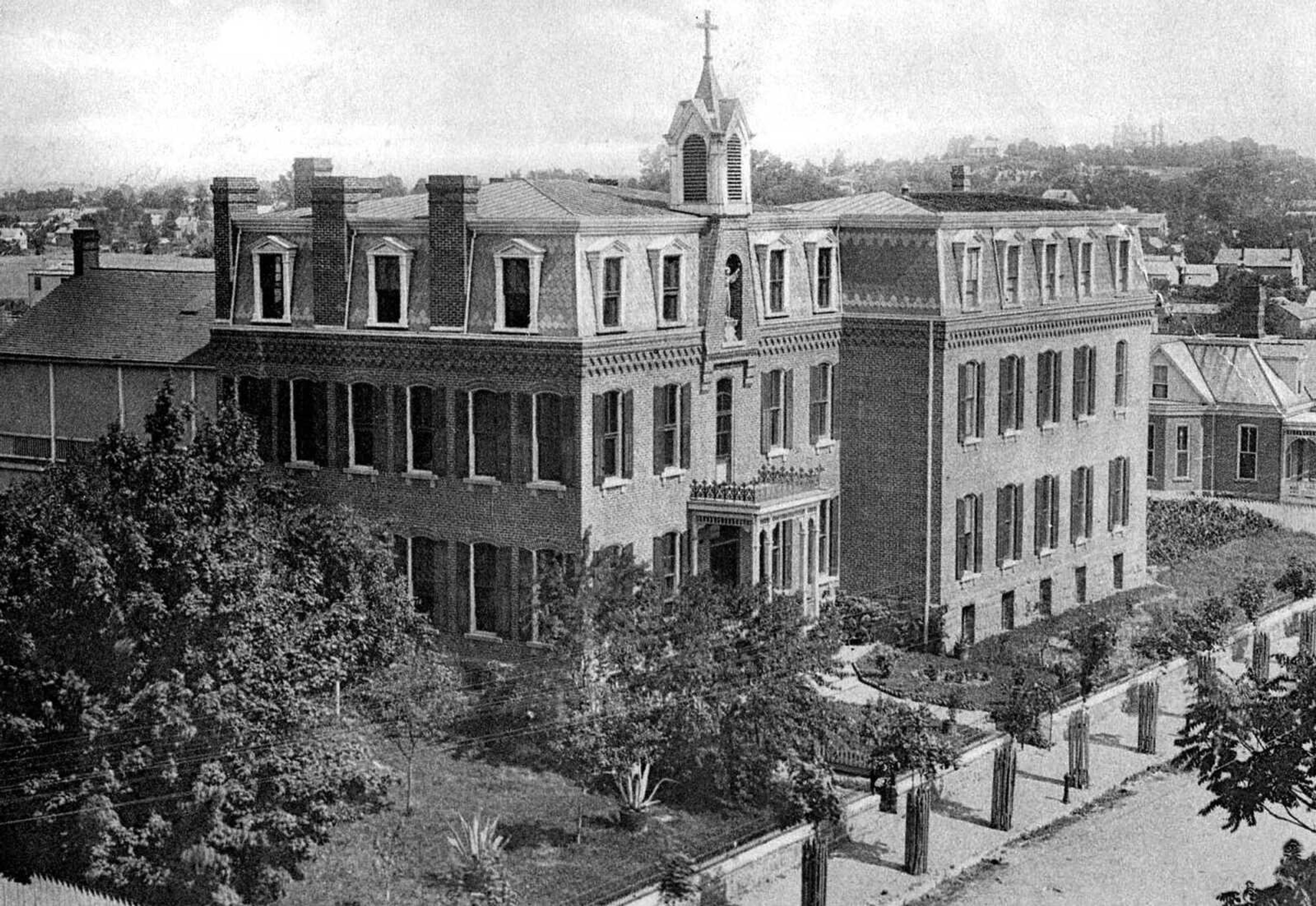 The statue of St. Francis of Assisi can be seen in an alcove below the belltower of St. Francis Hospital, northwest corner Sprigg and William streets. In 1882 the Franciscan Sisters built the west wing of the hospital facing William Street on a lot given them by Jack Painter. In 1900 they raised $42,000 to expand the hospital, and the north wing was added in 1901 at Sprigg and William. A model laundry plant was installed in 1905. The structure continued to be used as St. Francis Hospital until 1914, when a new facility was built at Good Hope and Pacific. The old hospital later became St. Mary's High School. (photo made from undated postcard)