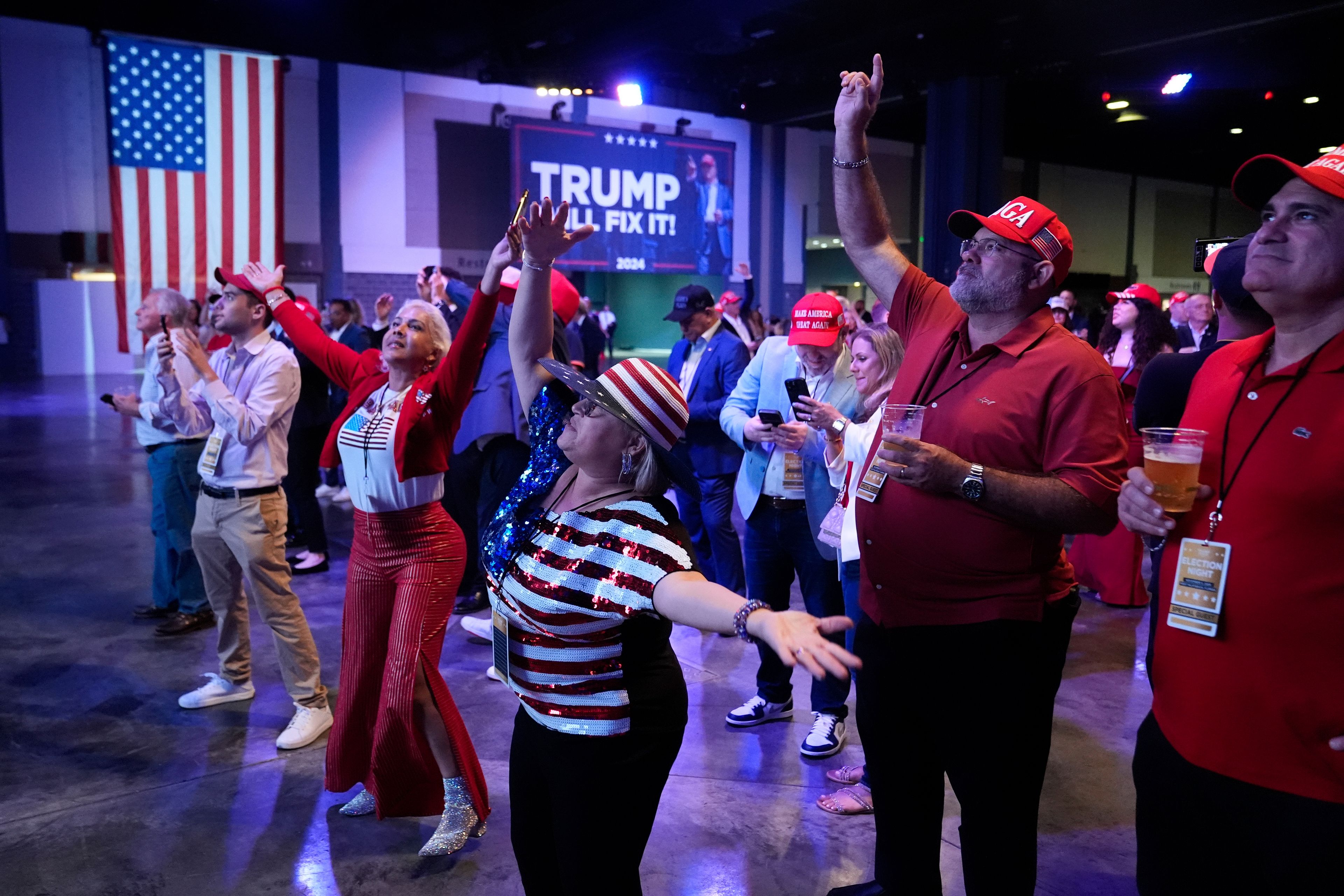 Supporters dance at an election night campaign watch party for Republican presidential nominee former President Donald Trump Tuesday, Nov. 5, 2024, in West Palm Beach, Fla. (AP Photo/Alex Brandon)