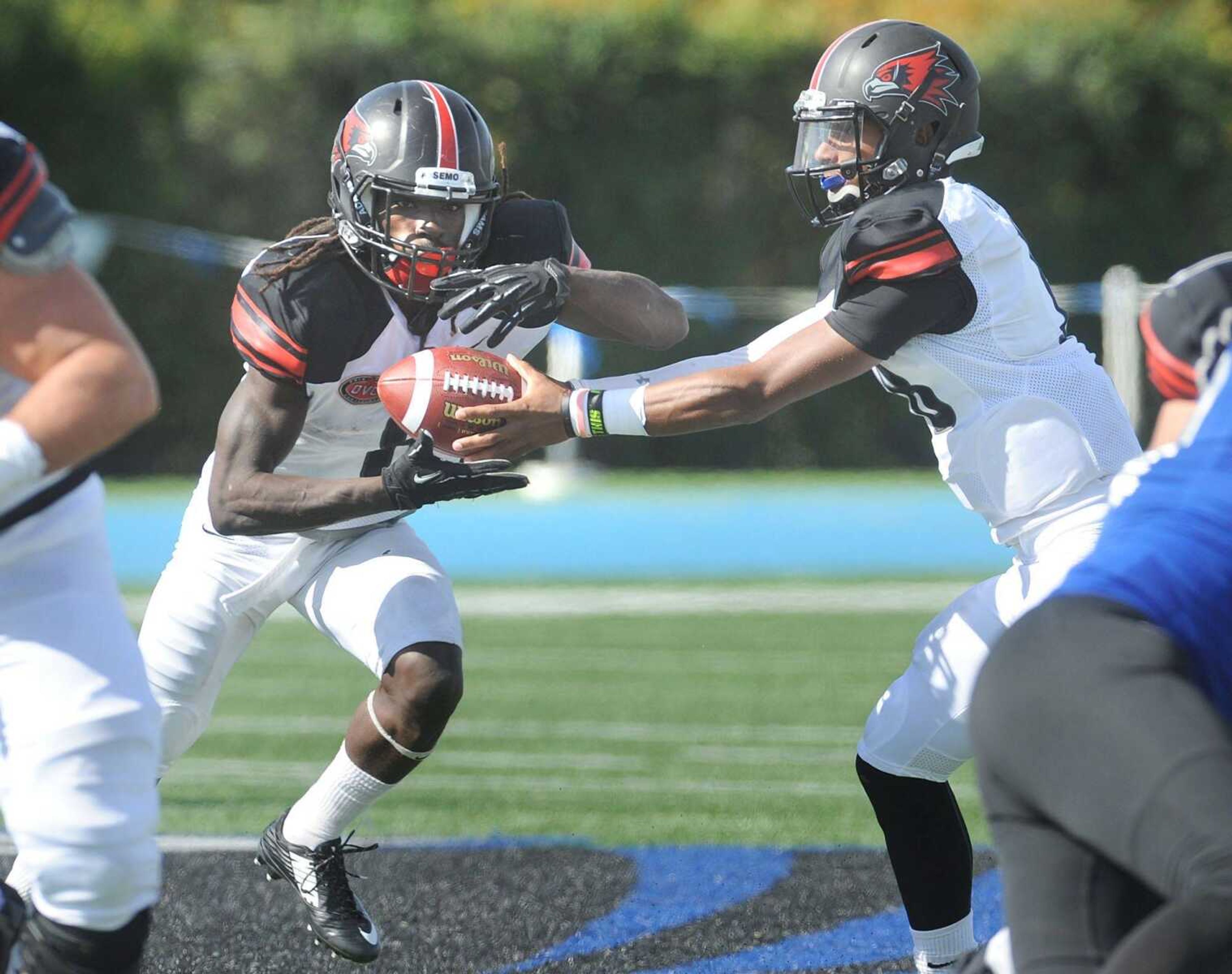 Southeast Missouri State quarterback Dante Vandeven hands off to Tremane McCullough against Eastern Illinois during the second quarter Saturday, Oct. 10, 2015 in Charleston, Illinois. (Fred Lynch)