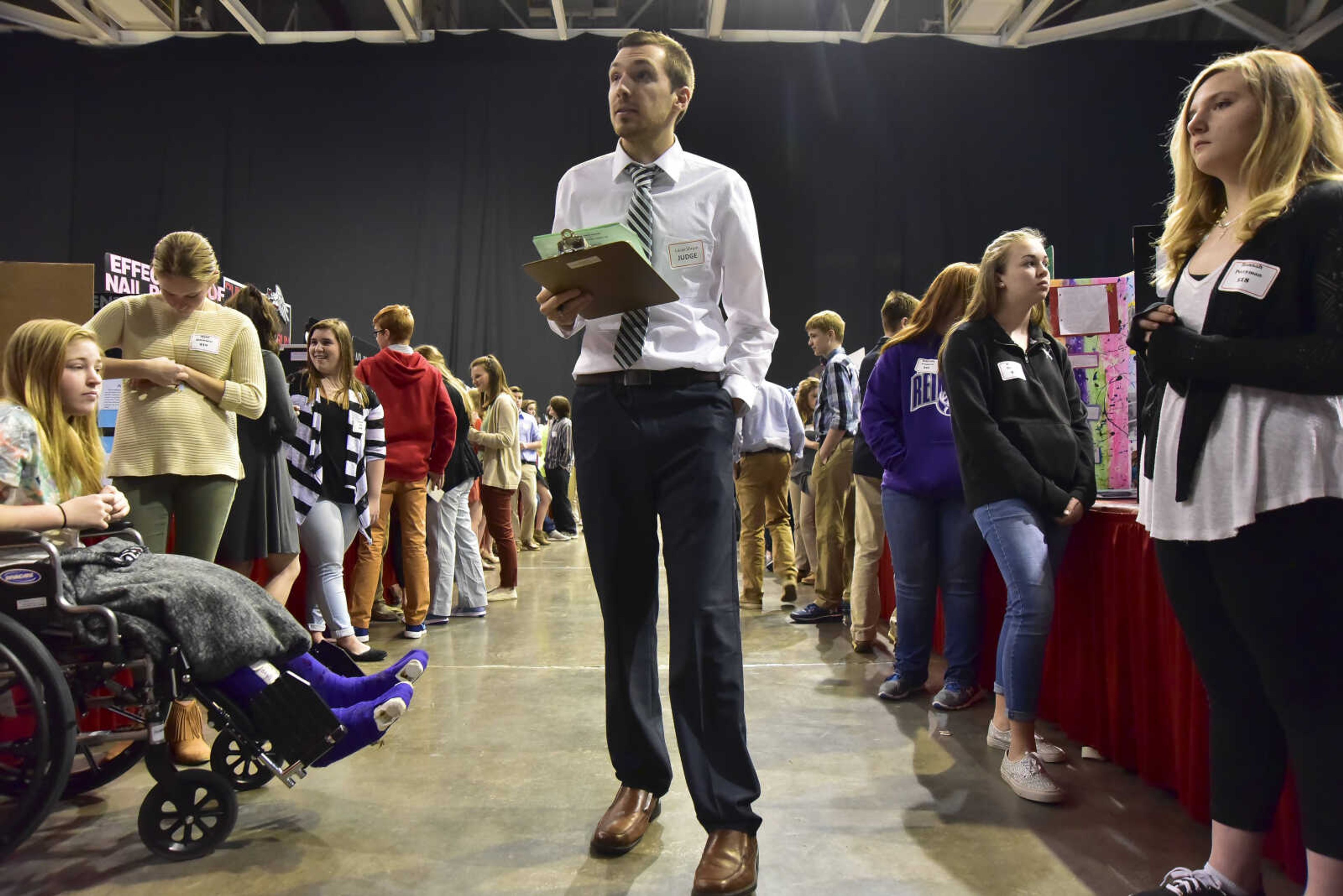 Judge Lucas Shrum walks around during the Southeast Missouri Regional Science Fair Tuesday, March 7, 2017 at the Show Me Center in Cape Girardeau.