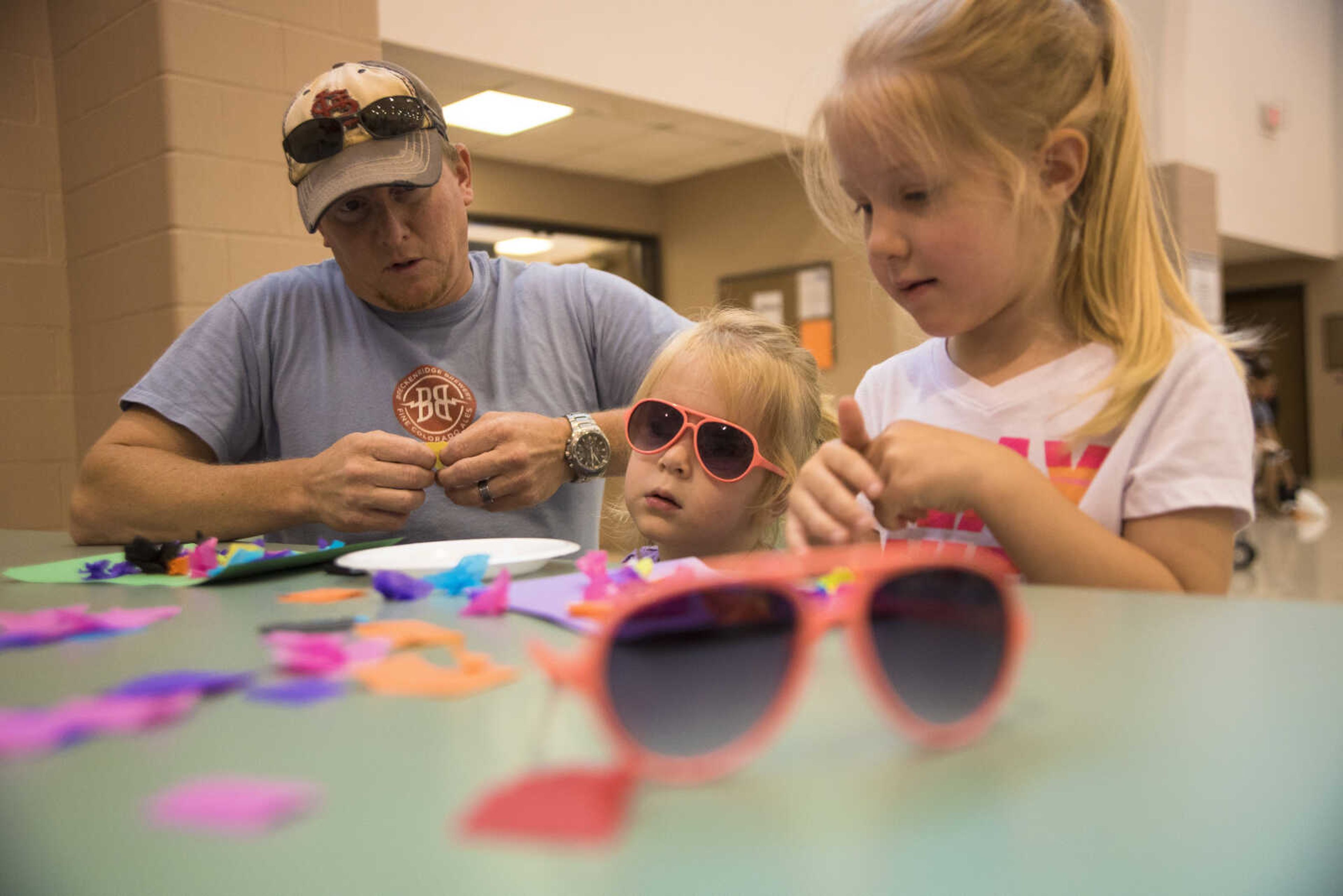 Ryan Garnett helps his daughters Maggie and Sophie with their arts and crafts during the Parks and Rec Day Friday, July 7, 2017 at the Osage Centre in Cape Girardeau.