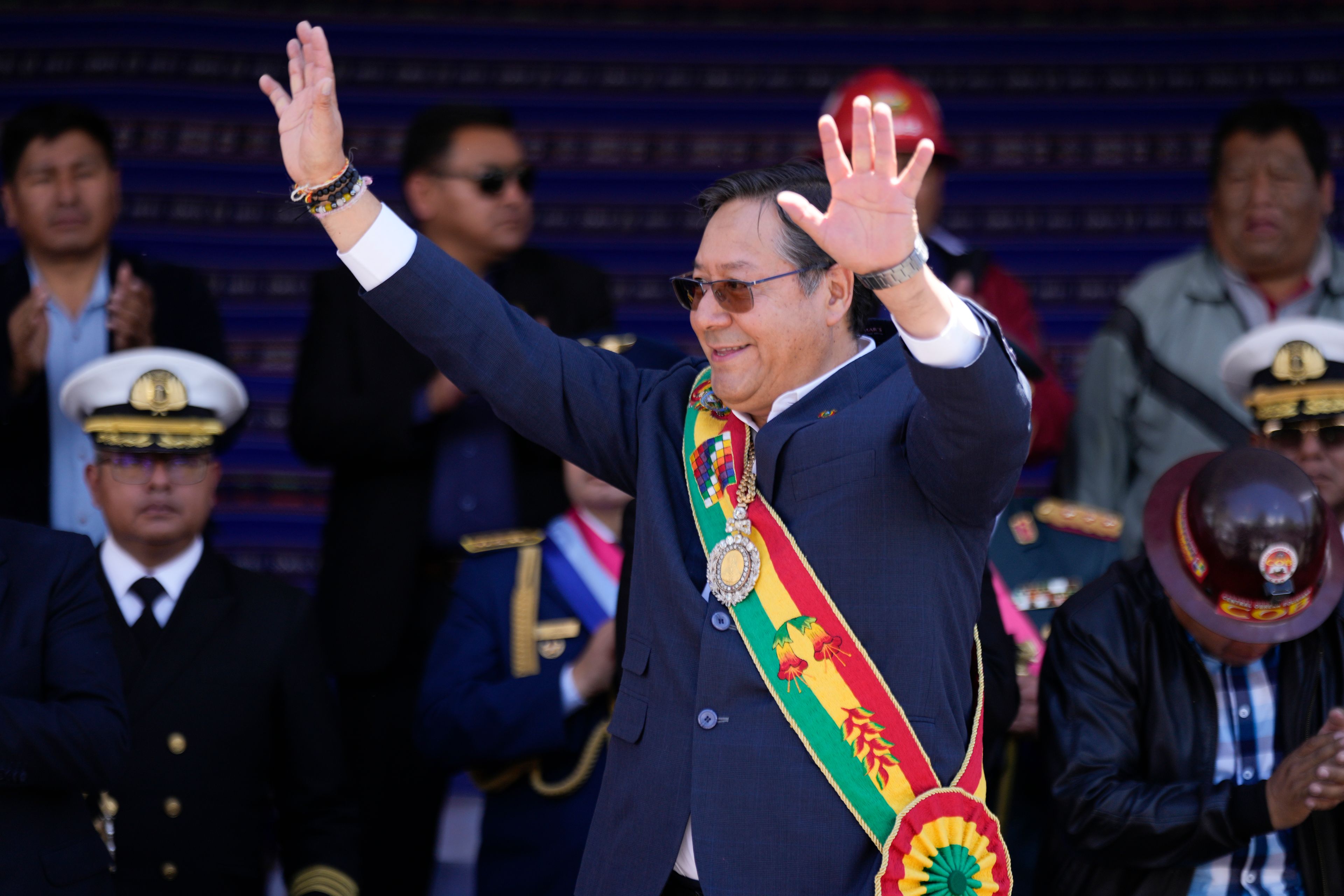 FILE - Bolivian President Luis Arce waves to supporters outside the government palace marking his fifth year in office, in La Paz, Bolivia, Nov. 8, 2024. (AP Photo/Juan Karita, File)