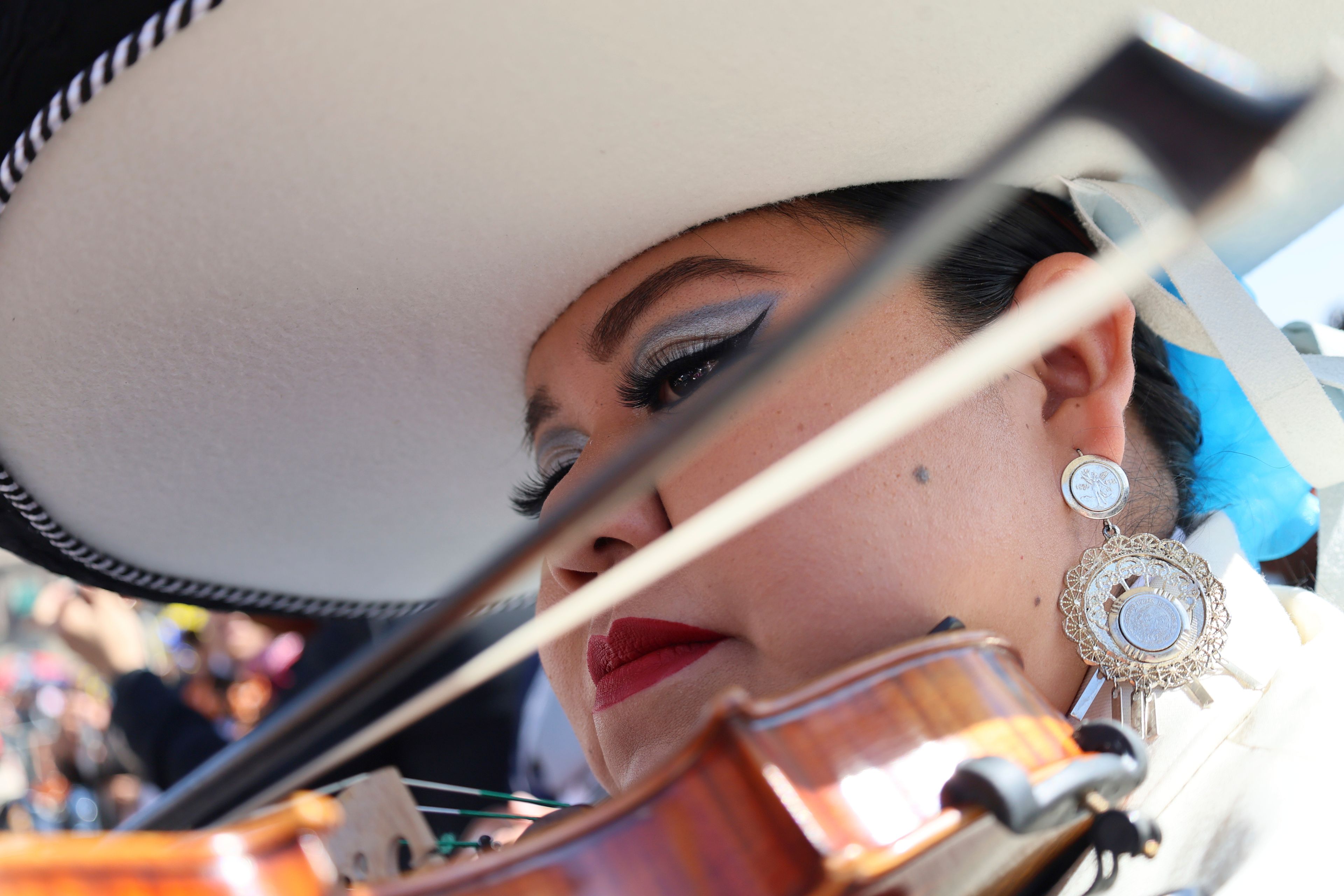 Daniela Orgin, plays her violin before a gathering to break the record of most mariachis performing in unison, at the Zocalo, Mexico City's main square, Sunday, Nov. 10, 2024. (AP Photo/Ginnette Riquelme)