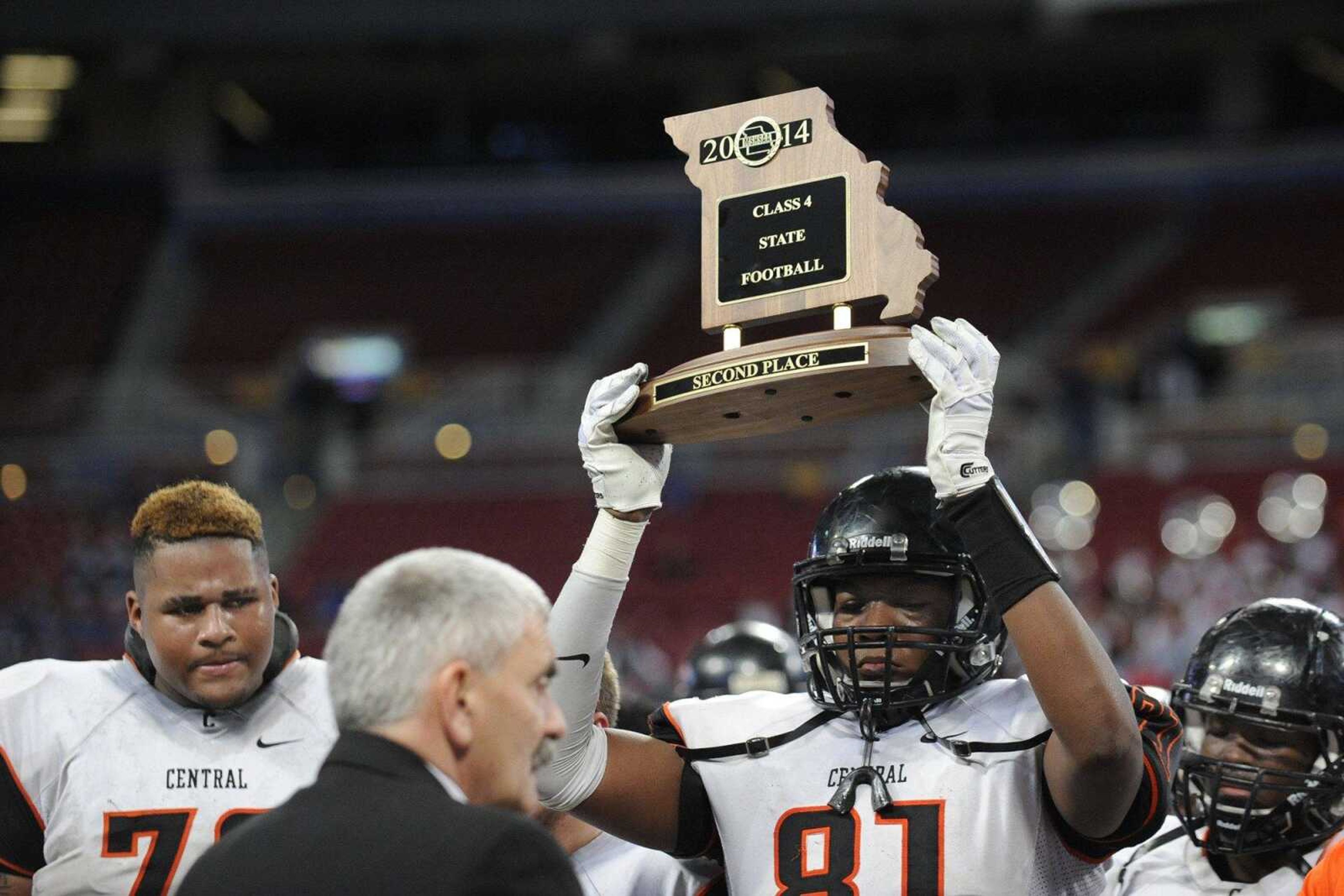 Central s Andre Statam hoists the second place trophy above his head after the Class 4 state championship against Webb City Saturday, Nov. 29, 2014 at the Edward Jones Dome in St. Louis. (Glenn Landberg)