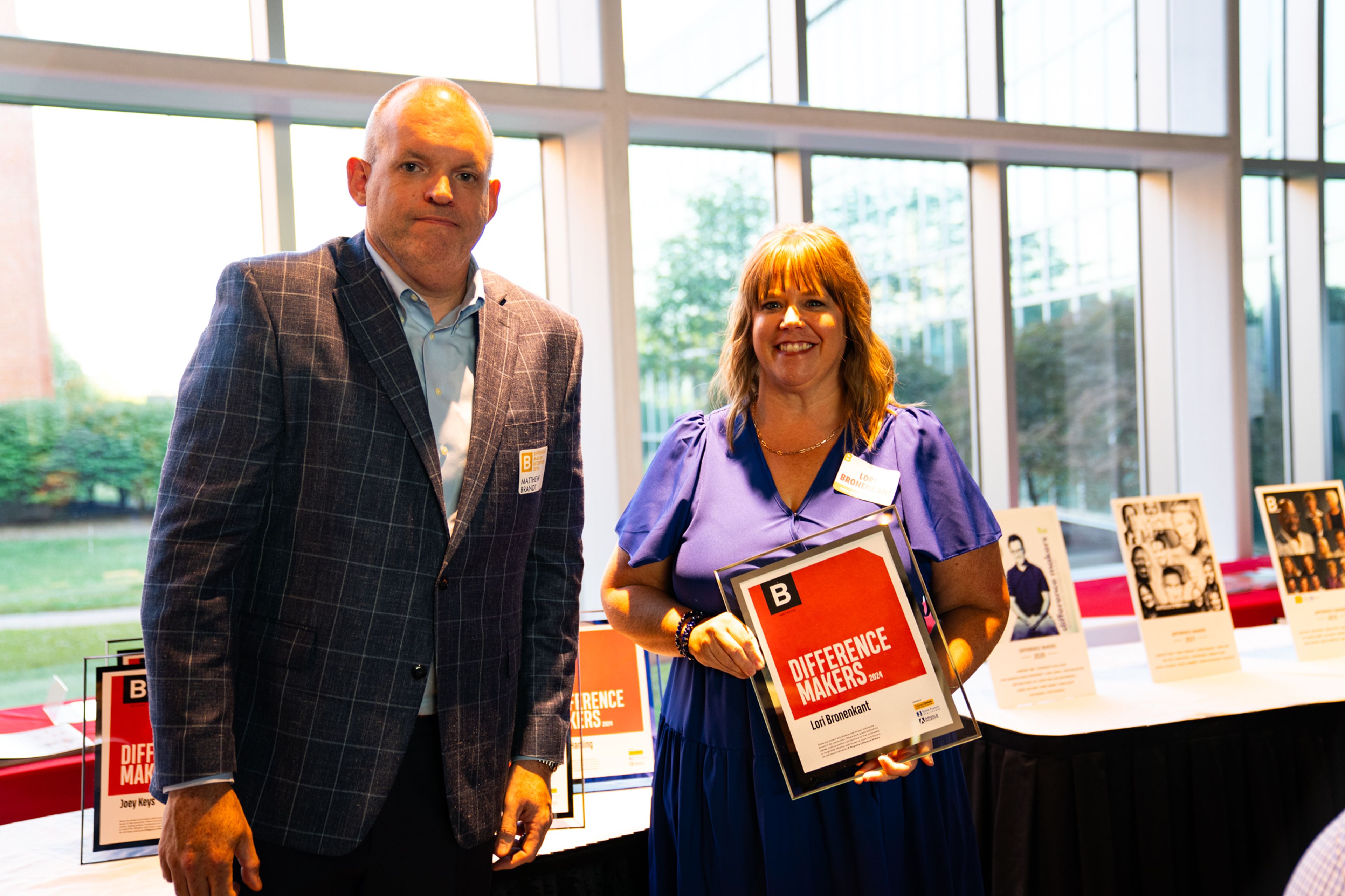 Lori Bronenkant receives a plaque from Saint Francis Healthcare System’s Matthew Brandt recognizing her as a 2024 Difference Maker at their reception at Southeast Missouri State University’s River Campus. The Difference Maker’s reception was presented by B Magazine on Thursday, Sept. 6.