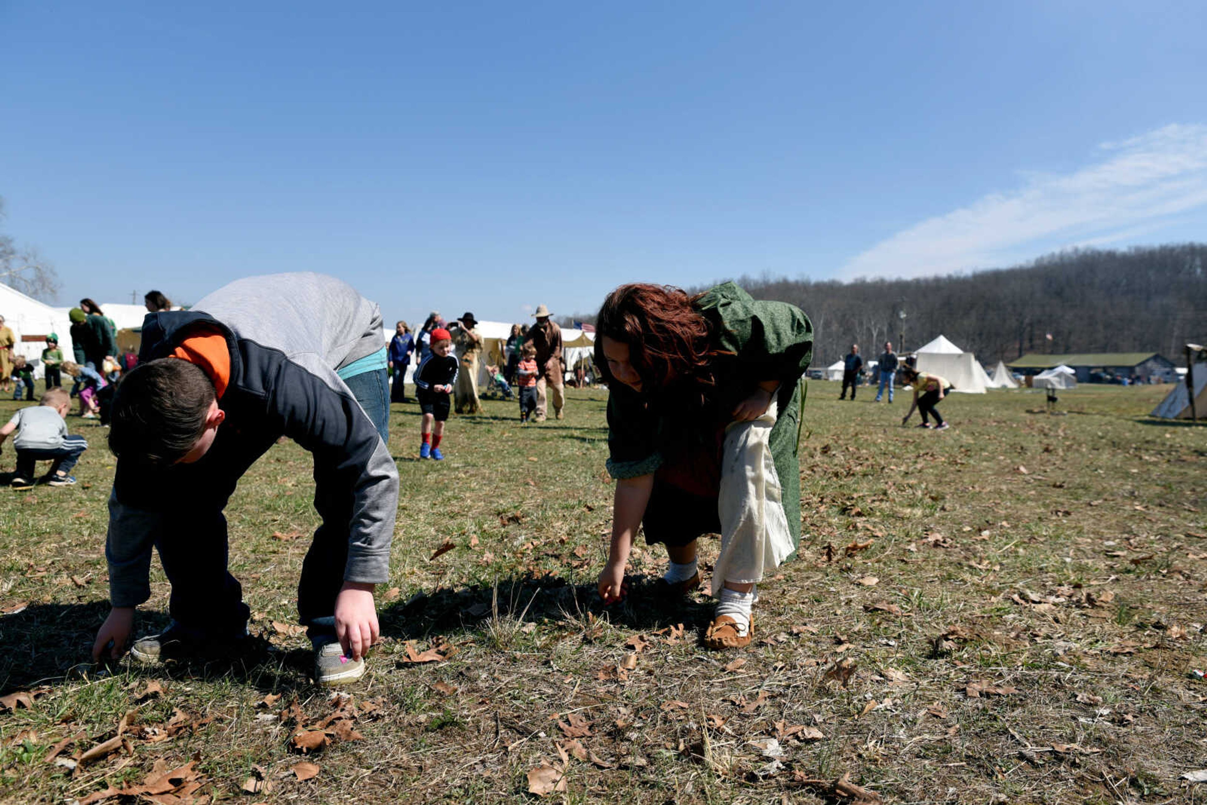 Kids pick up candy after the "candy cannon" at the second annual Eastern Ozark Rendezvous held at Bark's Planation Saturday, March 17, 2018, in Glenallen.