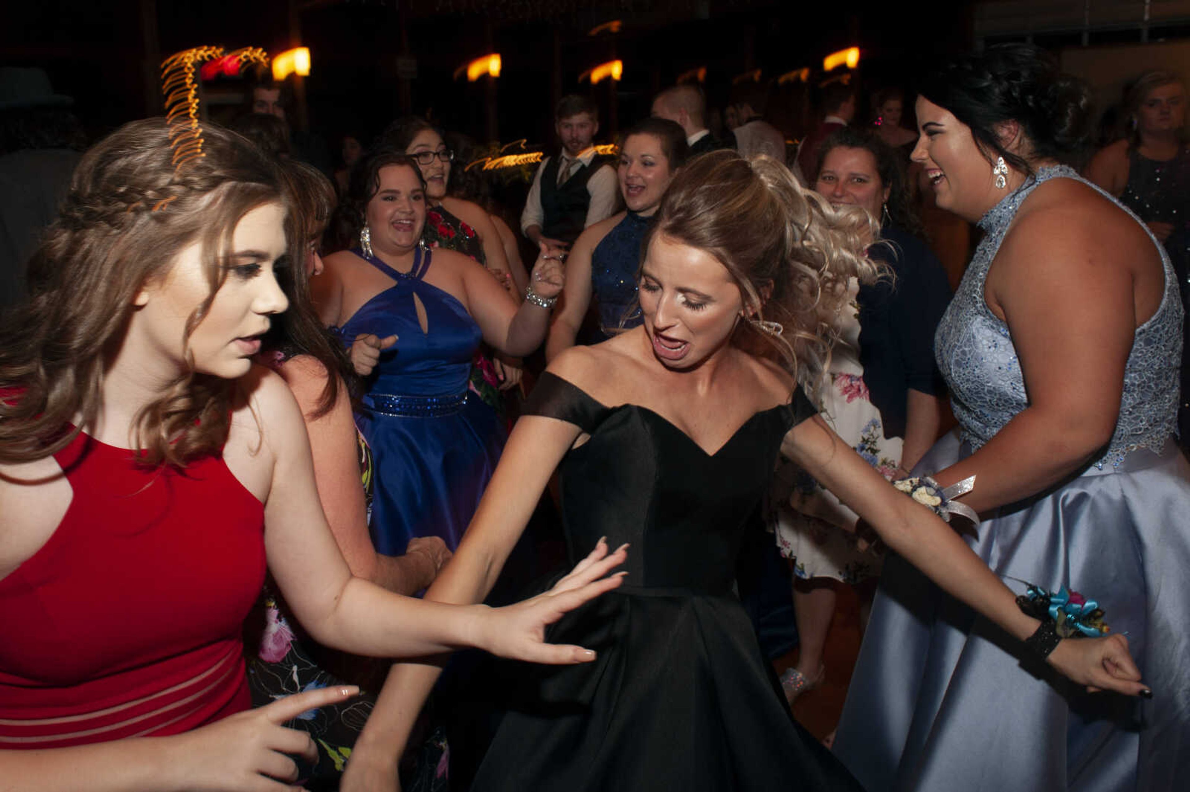 Scott City senior Paige Cummins, middle, dances next to Scott City junior Kassie Northington, left, and Scott City senior Courtney Enderle, right, during Scott City's prom Saturday, April 6, 2019, at Deerfield Lodge in Cape Girardeau.