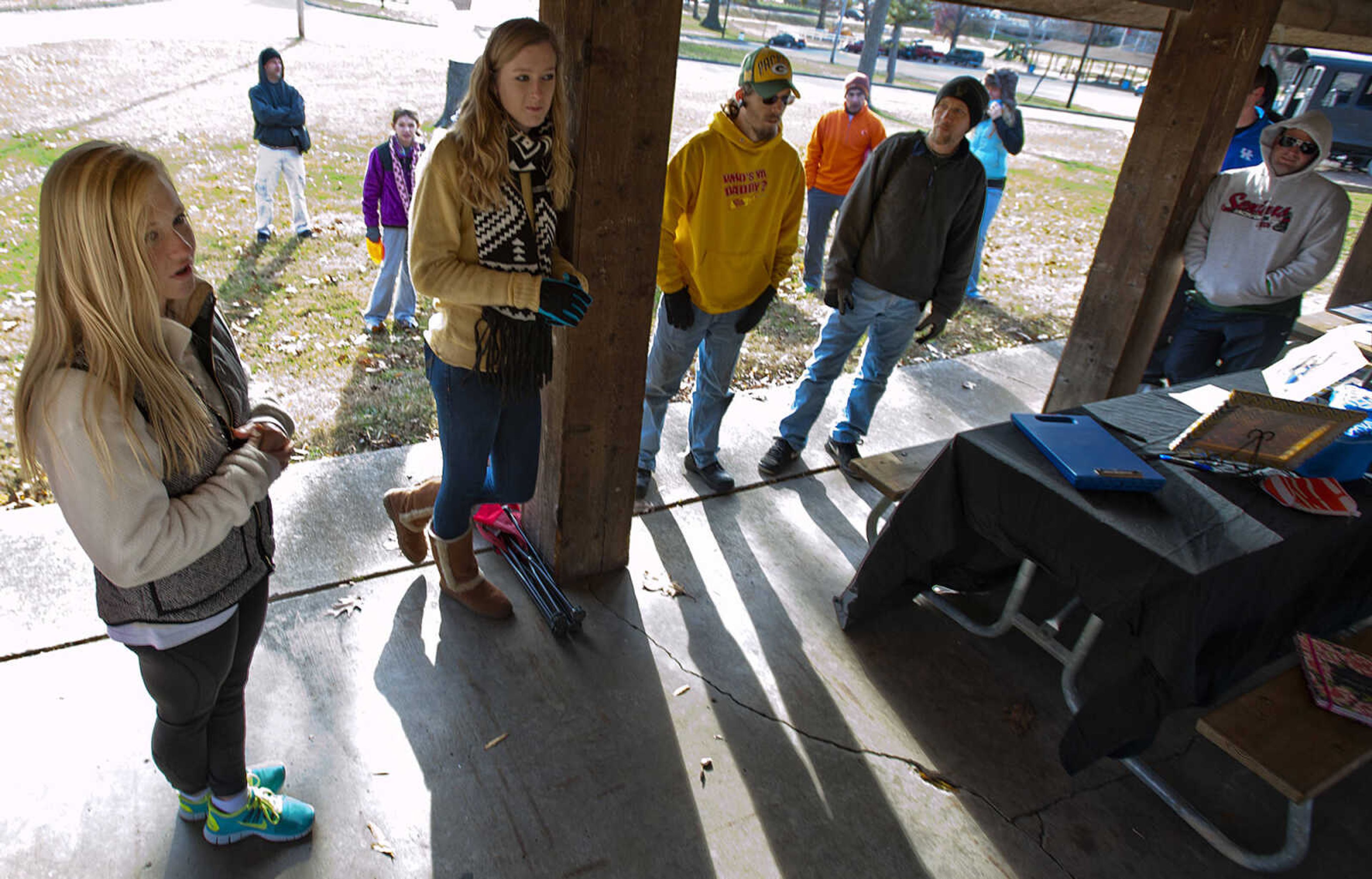 Sarah Stroup talks to participants before the start of the Fountain of Life Disc Golf Tournament Sunday, Nov. 24, at Capaha Park in Cape Girardeau. Stroup estimated that approximately 30 people played in the tournament which raised around $2,500 which will go towards construction of a fresh water well for a village in Swaziland, Africa.