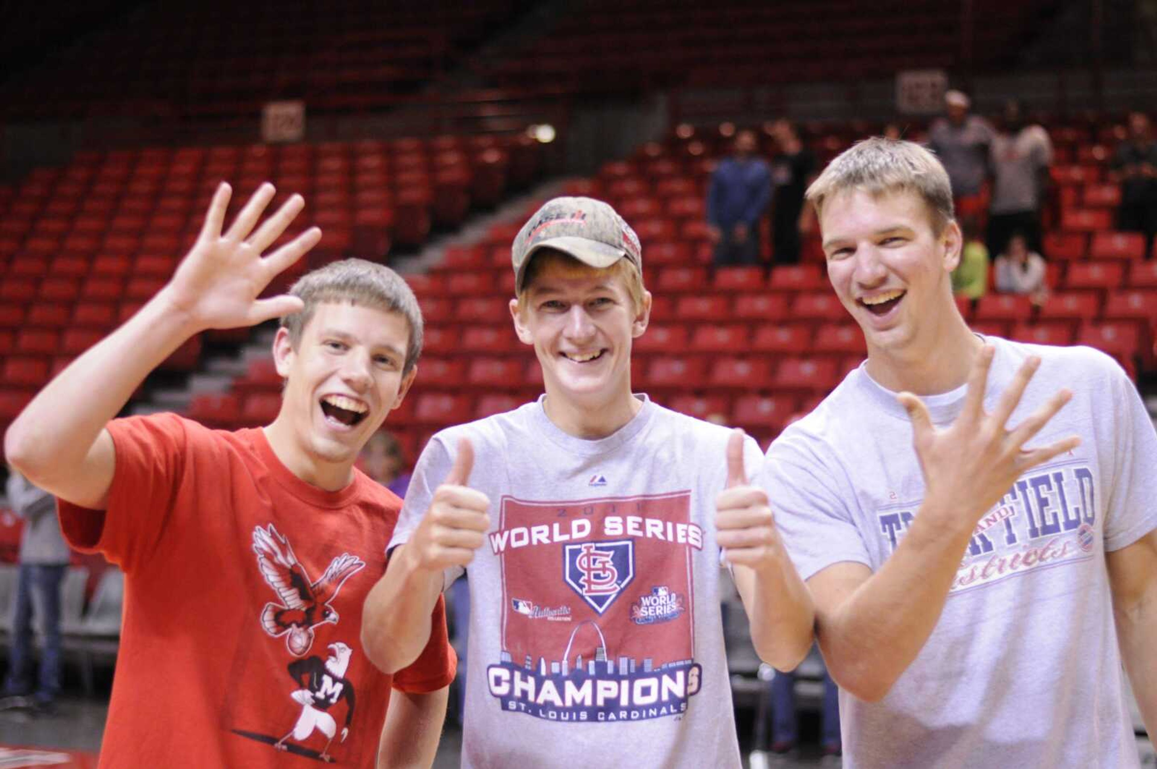 Matt Brucker, center, a junior at Southeast Missouri State, celebrates with friends after winning $5,000 at Sunday's Midnight Madness at the Show Me Center. Brucker, who a graduate of Delta High School, hit a half-court shot to win the prize. (Alyssa Brewer ~ Special to Southeast Missourian)