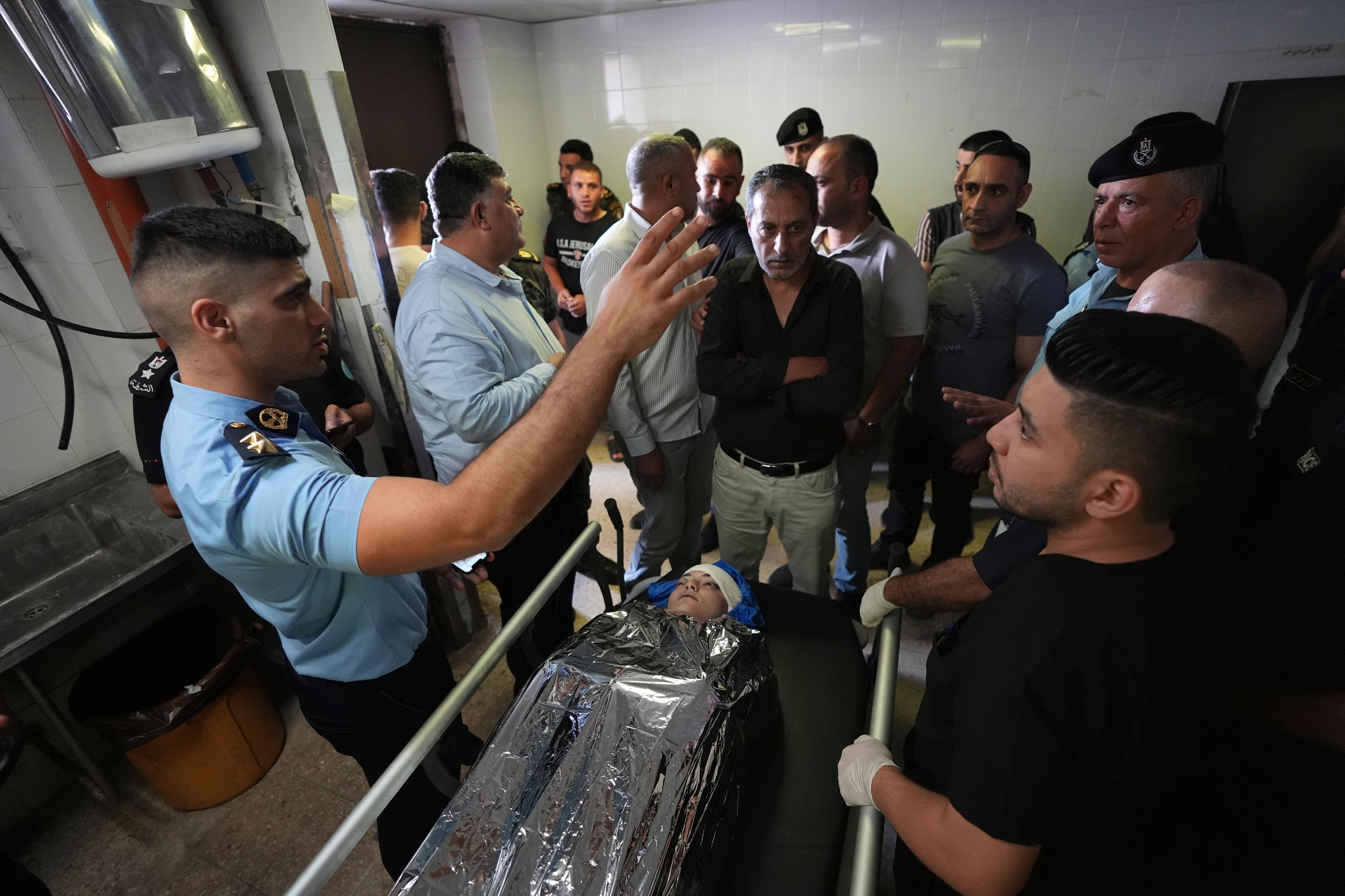 Palestinians gather around the body of Aysenur Ezgi Eygi, 26, who was fatally shot by Israeli soldiers while participating in an anti-settlement protest in the West Bank, at the morgue of the Rafedia hospital, in the West Bank city of Nablus Friday, Sept. 6, 2024. (AP Photo)