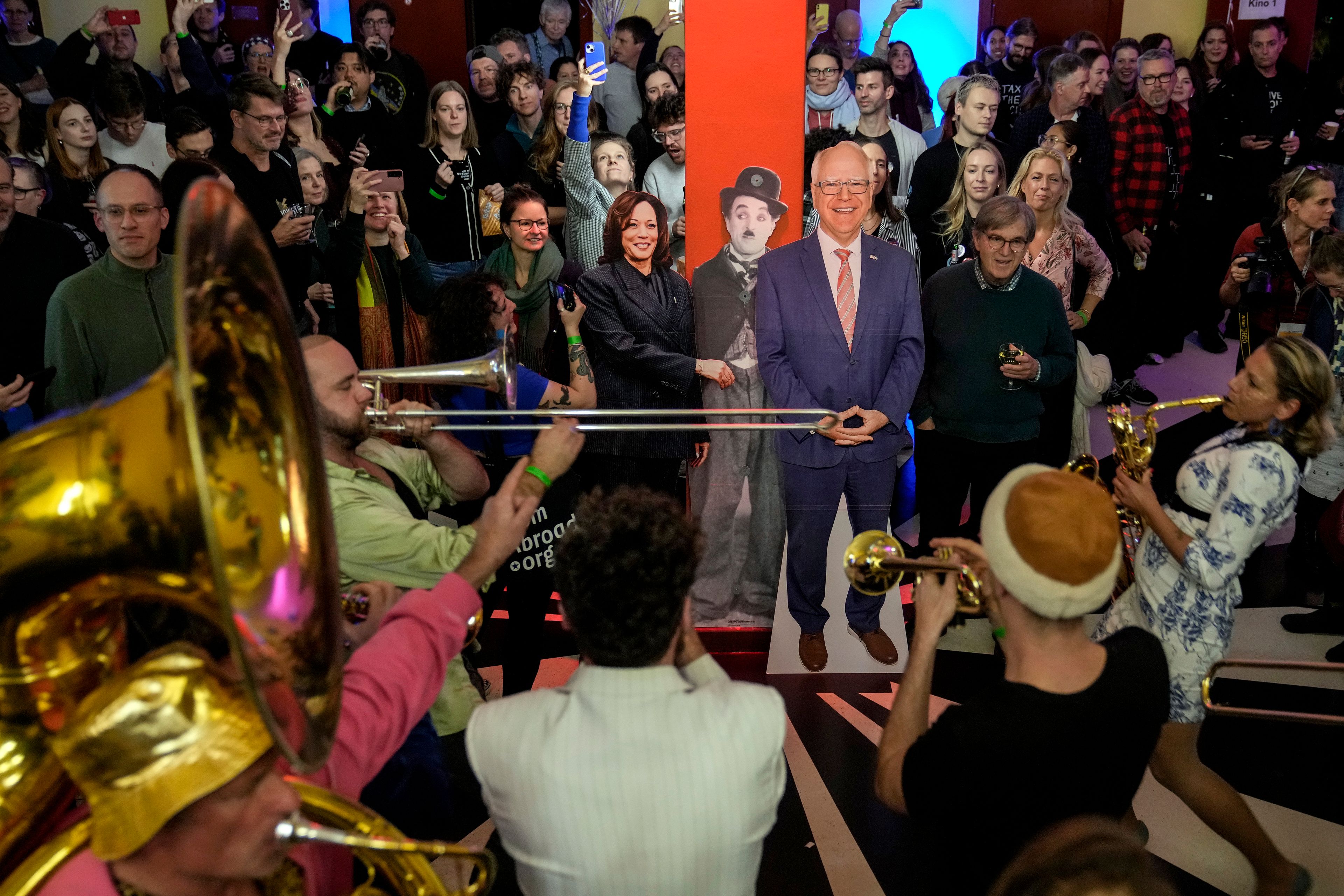 Supporters of U.S. Democratic presidential nominee Vice President Kamala Harris attend the U.S. presidential election night party of the Democrats Abroad while surrounding the cutouts of her and vice presidential nominee Minnesota Gov. Tim Walz at the Babylon cinema in central Berlin, Germany, Tuesday, Nov. 5, 2024. (AP Photo/Ebrahim Noroozi)