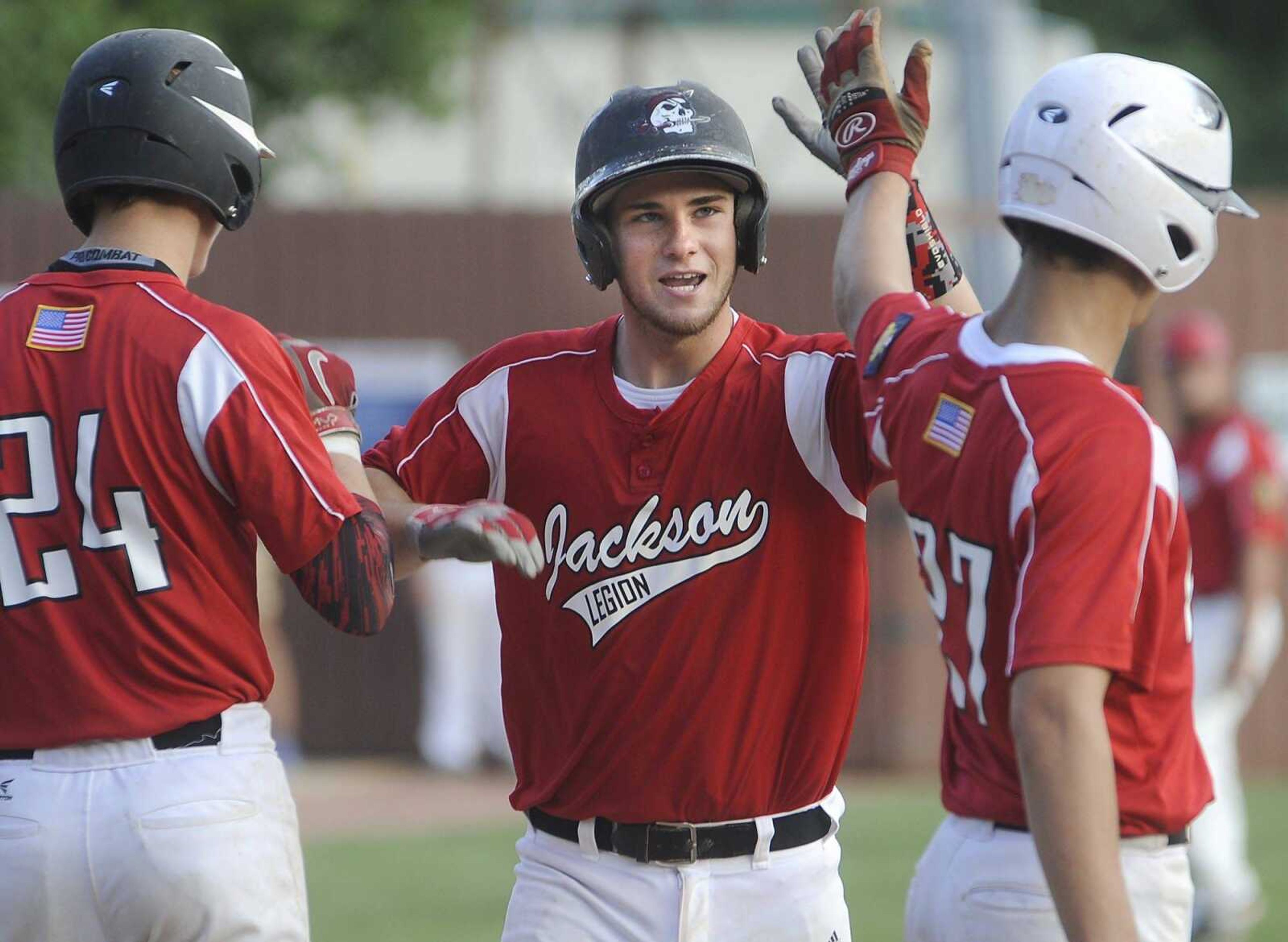 Jackson Post 158's Tristen Burdette is congratulated by Wyatt Eldridge, left, and Ben Maudie after Burdette's three-run home run against Ballwin Post 611 during the fifth inning of the Zone 4 Senior American Legion tournament Thursday in Farmington, Missouri. Jackson won 18-4. (Fred Lynch)