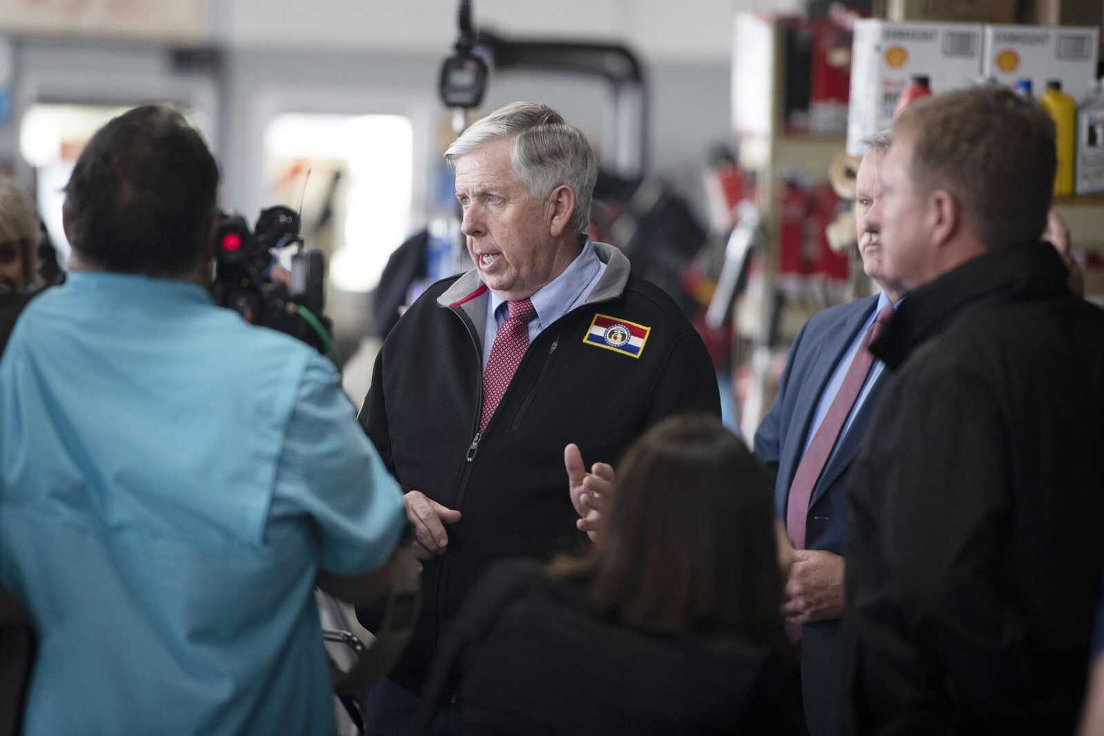 Missouri Gov. Mike Parson, center, speaks while making a visit Thursday, May 14, 2020, at Plaza Tire Service at 170 S. Kingshighway in Cape Girardeau. Following his visit, Gov. Parson returned to Jefferson City for a briefing to give updates on COVID-19 in the state.