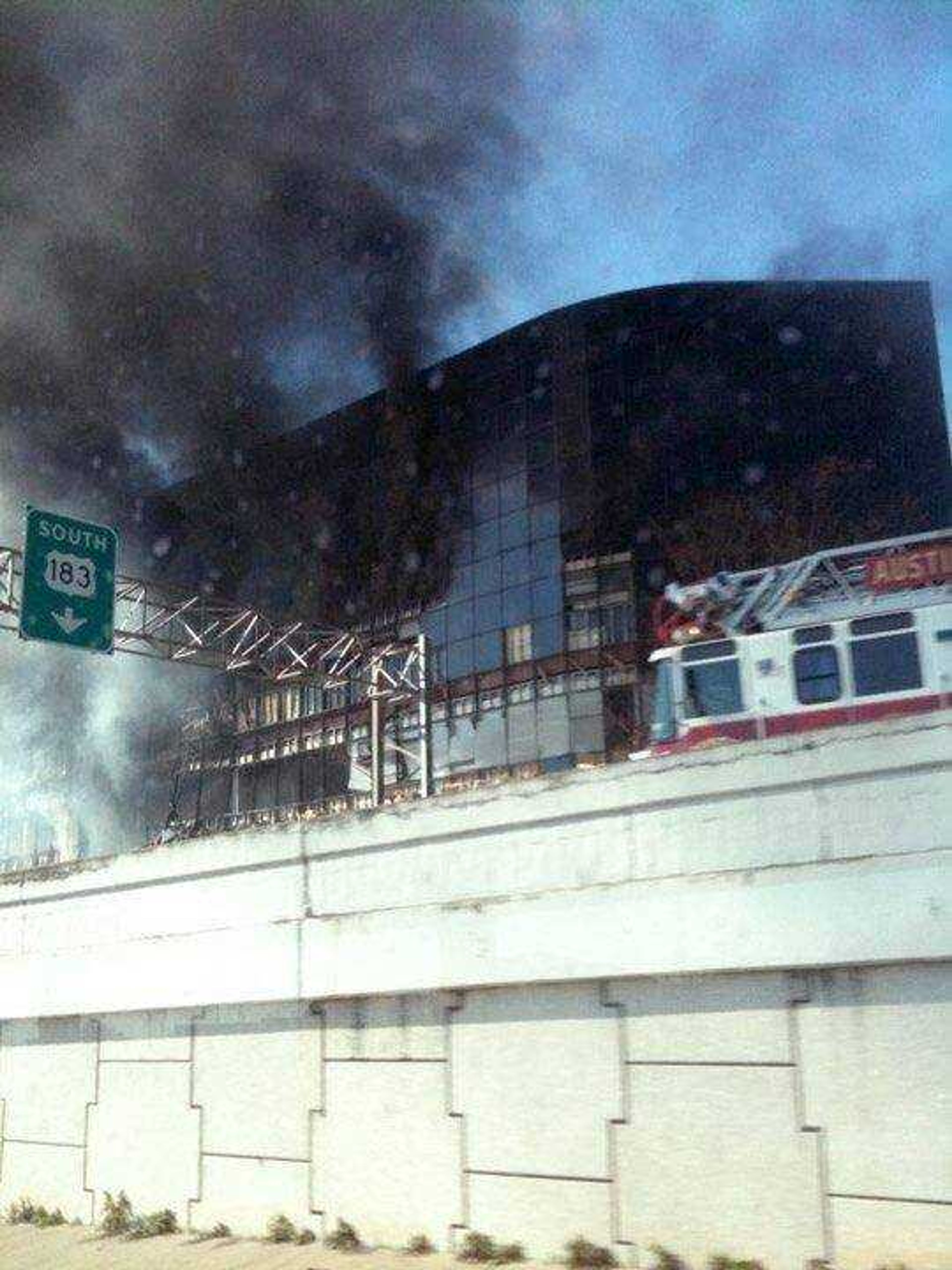 In this photo provided by Grant Abston, smoke billows from a seven-story building after a small private plane crashed into the building  in Austin, Texas on Thursday Feb. 18, 2010. (AP Photo/Courtesy Grant Abston)