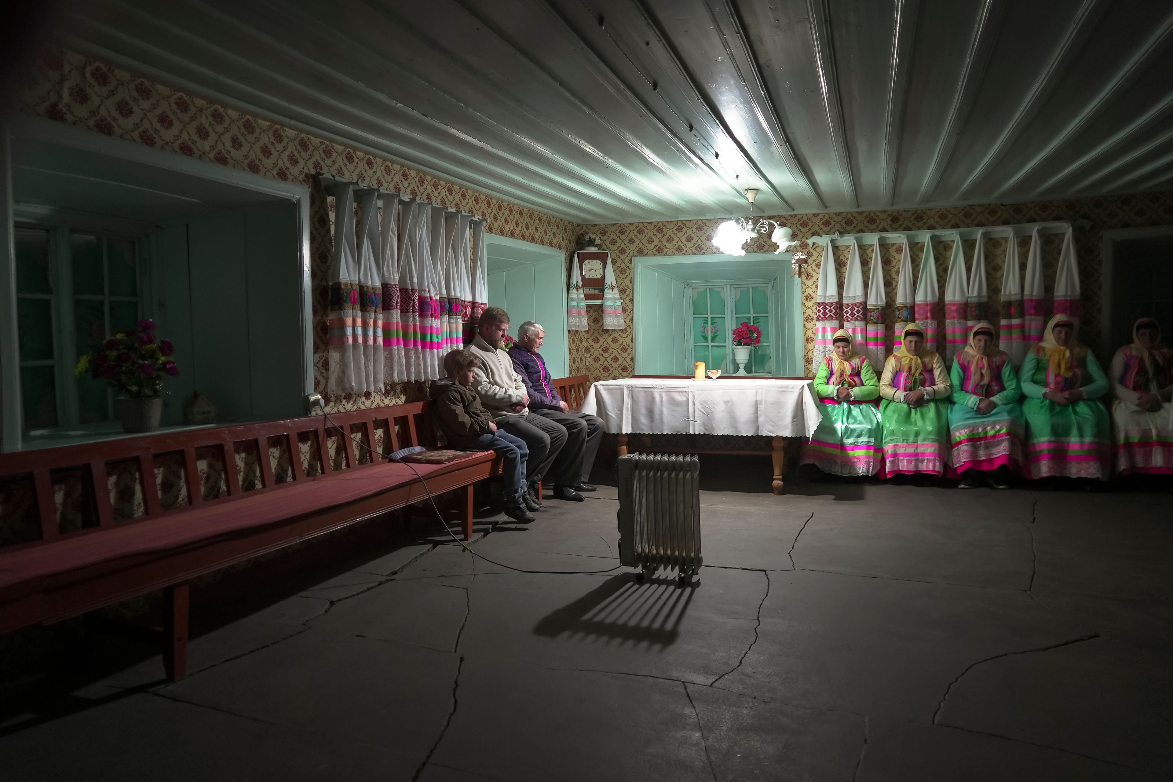 Yuri Strukov, second left, and his son Ilya, left, pray at the former Orphanage house where Doukhobors has worshiped for years, on Easter in the remote mountain village of Gorelovka, Georgia, Saturday, May 4, 2024. (AP Photo/Kostya Manenkov)