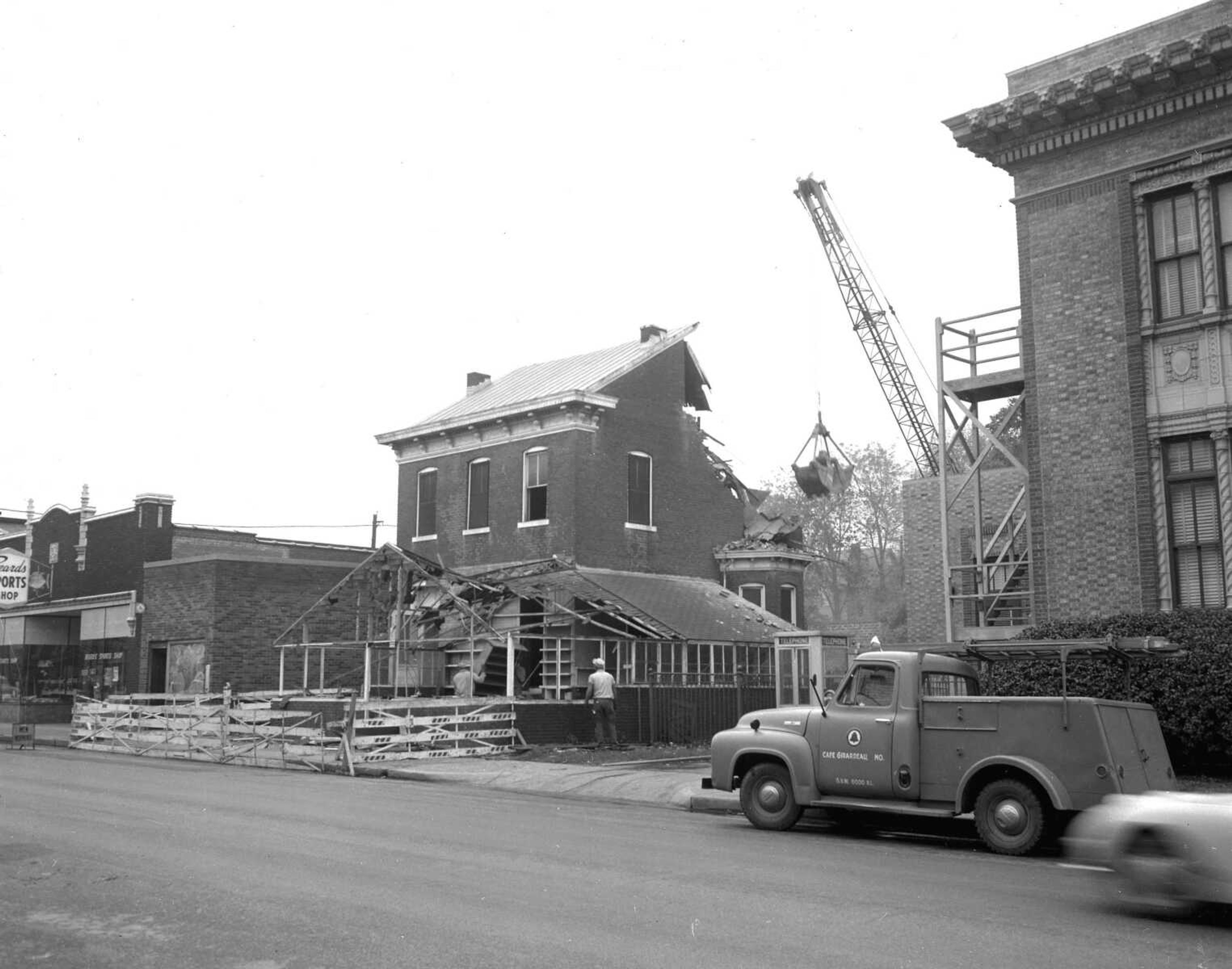 The former August Bierwirth home, later converted into a florist shop by the Cherry family, was razed in 1962 to make way for an addition to the telephone building at right. (Missourian archive photo by G.D. "Frony" Fronabarger)