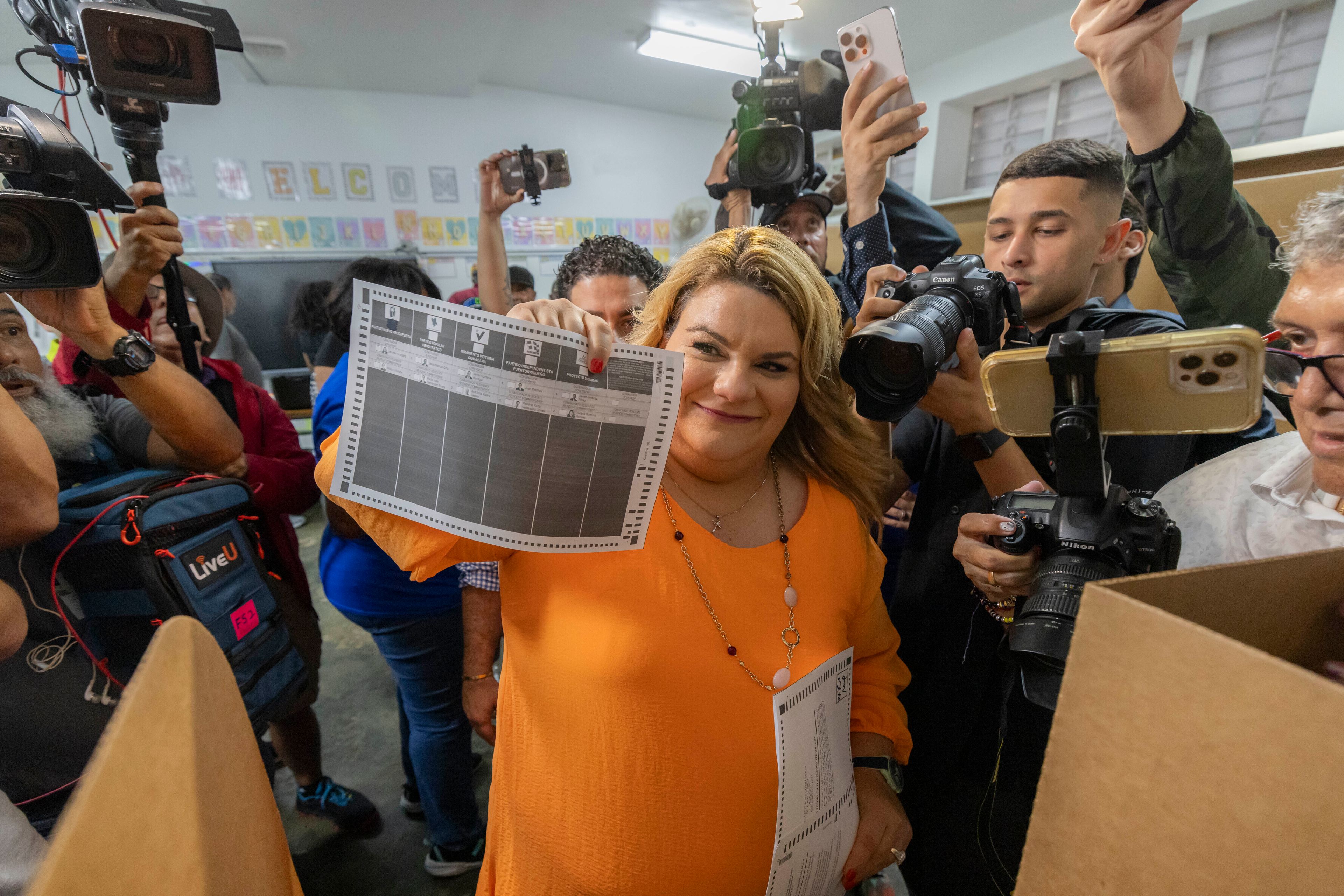 Jenniffer González, Puerto Rico's New Progressive Party candidate for Governor, shows her ballot during general elections in San Juan, Puerto Rico, Tuesday, Nov. 5, 2024. (AP Photo/Alejandro Granadillo)