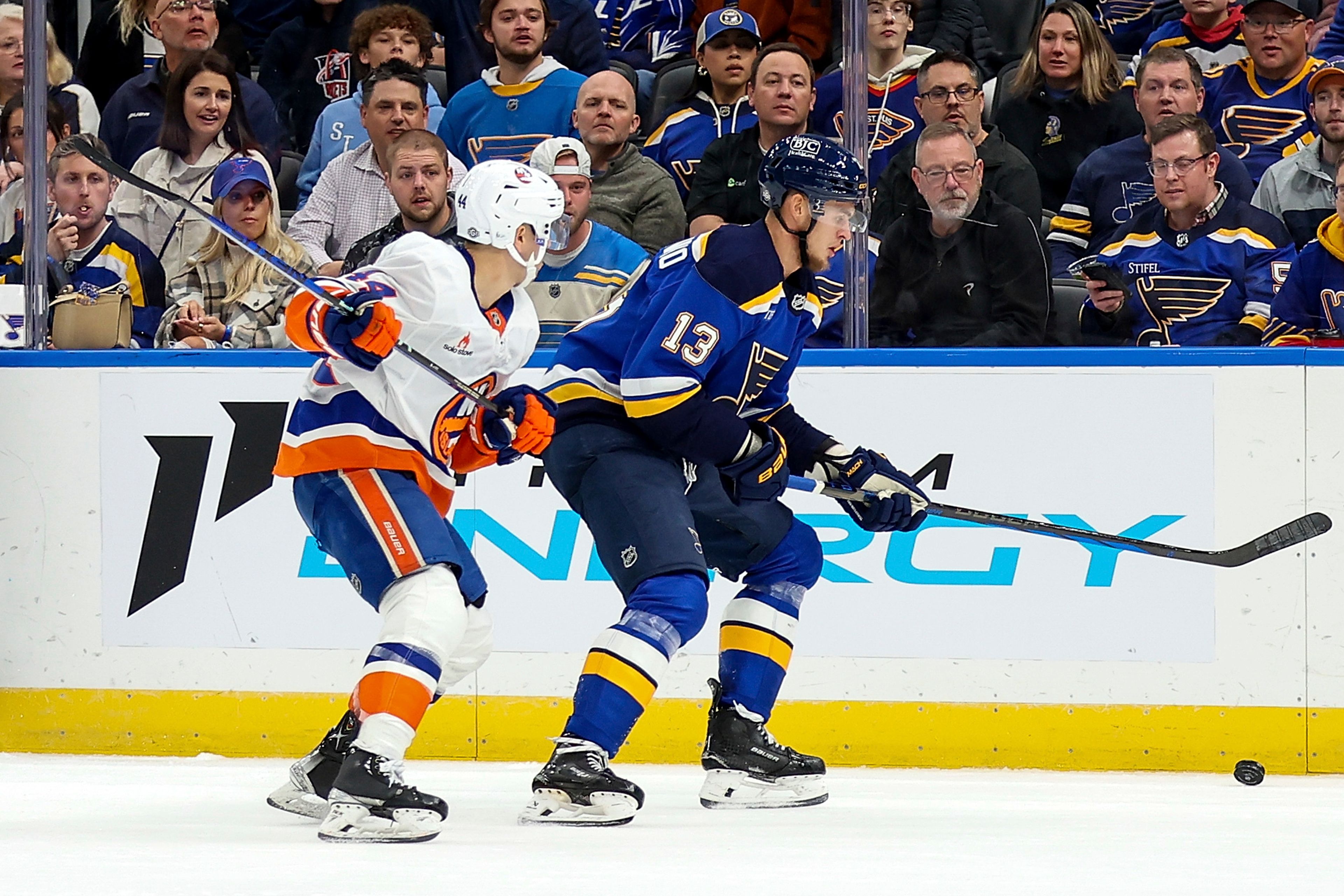 St. Louis Blues' Alexey Toropchenko (13) and New York Islanders' Jean-Gabriel Pageau (44) vie for control of the puck during the second period of an NHL hockey game Thursday, Oct. 17, 2024, in St. Louis. (AP Photo/Scott Kane)