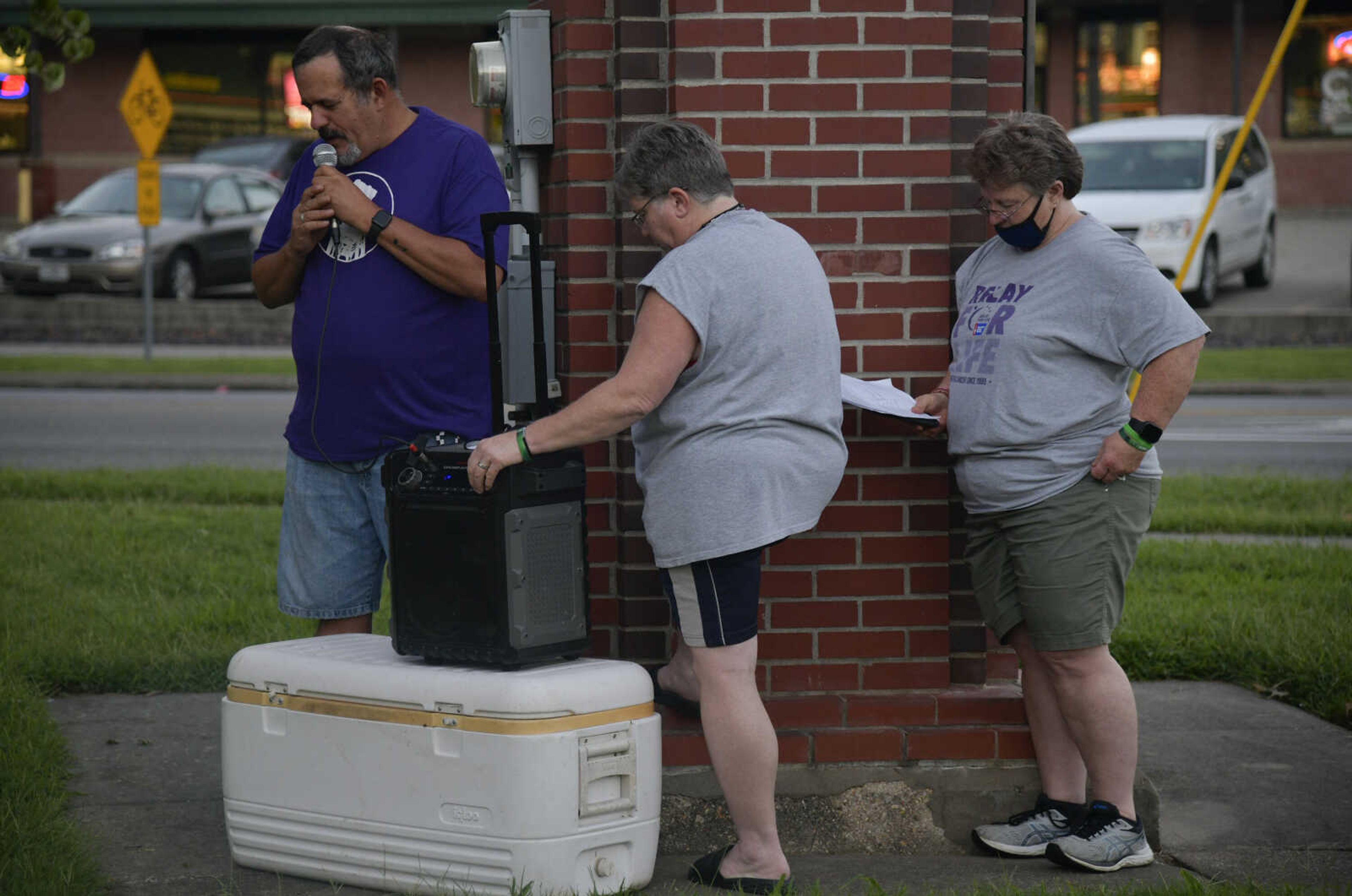 Left, Brad Rosenthal says a prayer at the International Overdose Awareness Day Honor Walk that began at Freedom Corner in Capaha Park on Monday, Aug. 31, 2020.