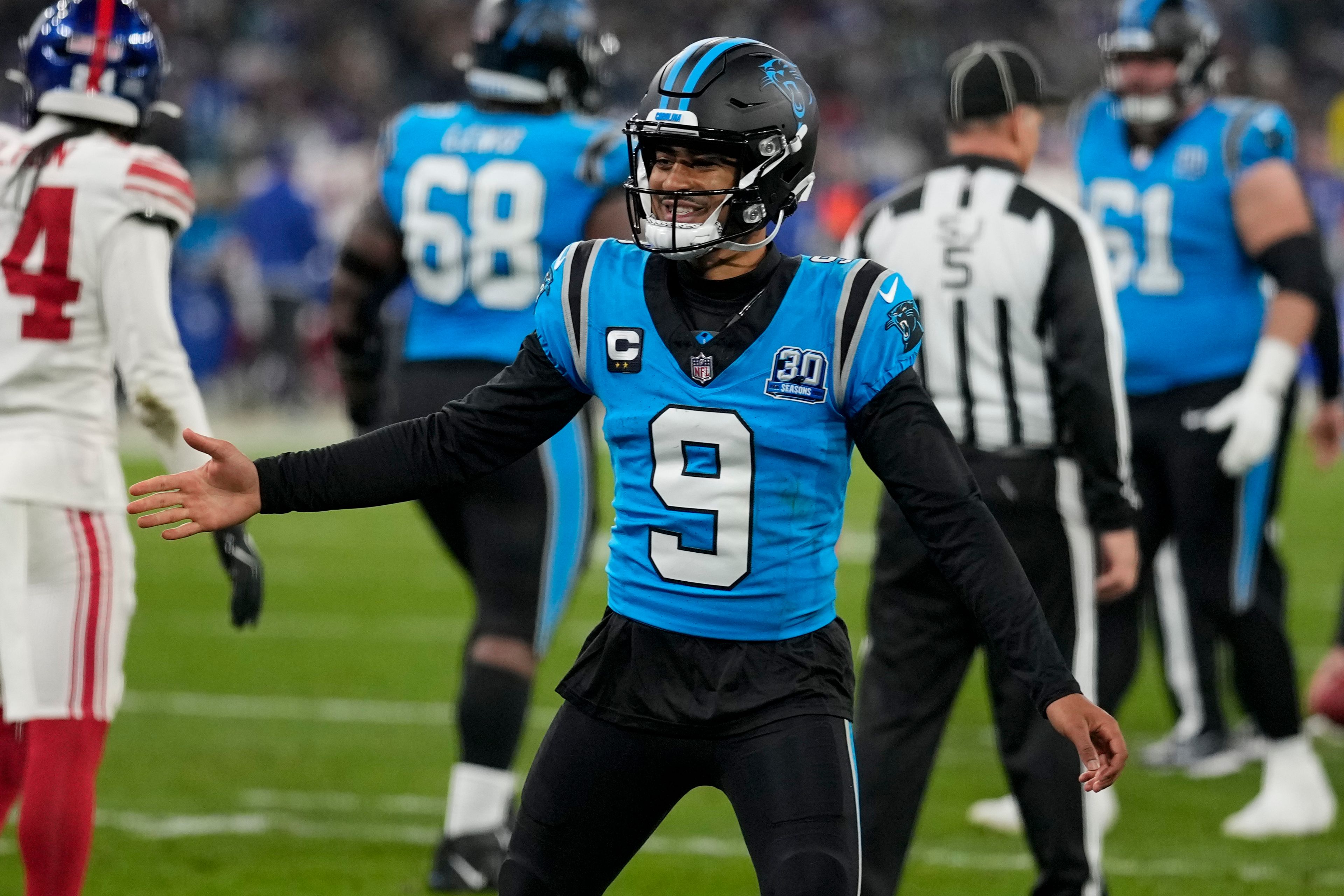 Carolina Panthers quarterback Bryce Young celebrates after a touchdown by running back Chuba Hubbard during the second half of an NFL football game against the New York Giants, Sunday, Nov. 10, 2024, in Munich, Germany. (AP Photo/Matthias Schrader)