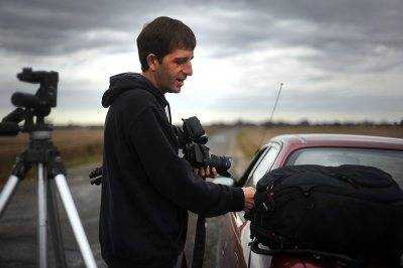 LAURA SIMON ~ lsimon@semissourian.com 
  
 David Patterson packs up his camera at one of his favorite weather watching spots in Southern Illinois, Tuesday, Oct. 28, 2014.