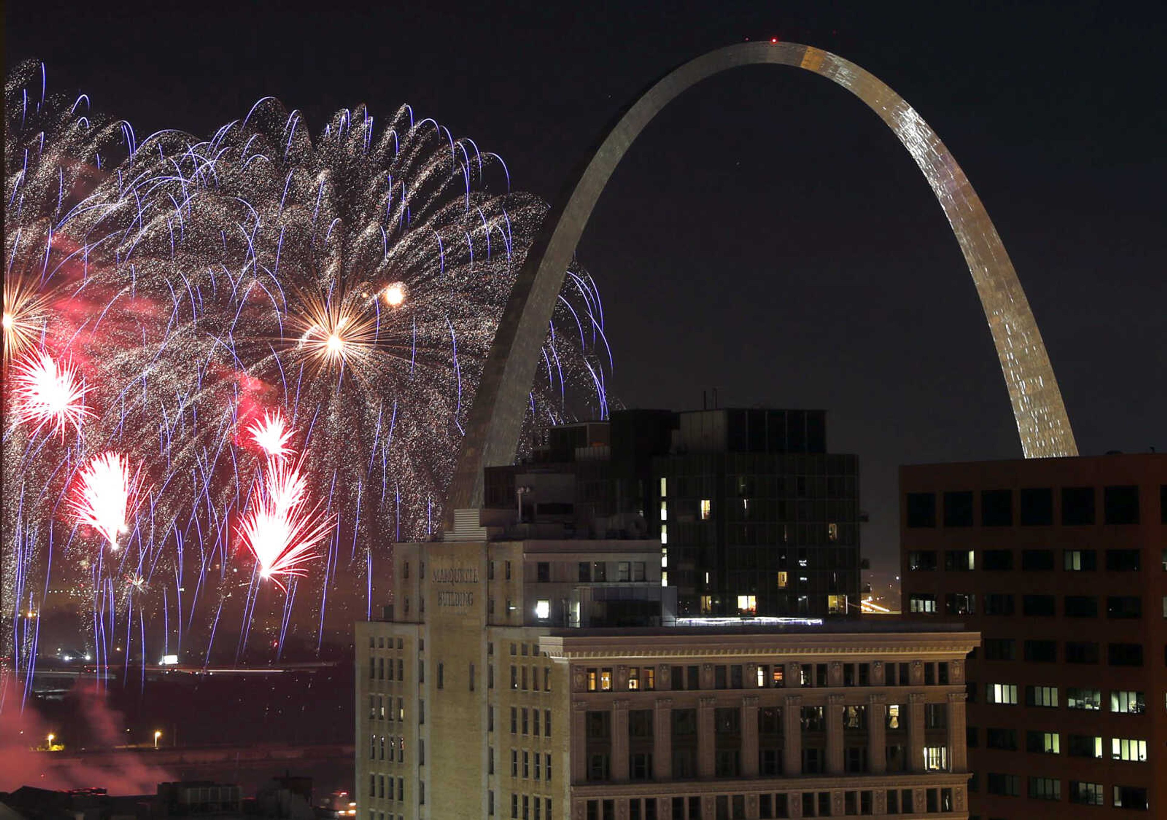 Fireworks illuminate the night sky near the Gateway Arch on July 4 in St. Louis. A task force called Better Together on Monday revealed a plan calling for a statewide vote seeking approval to merge St. Louis city and county.