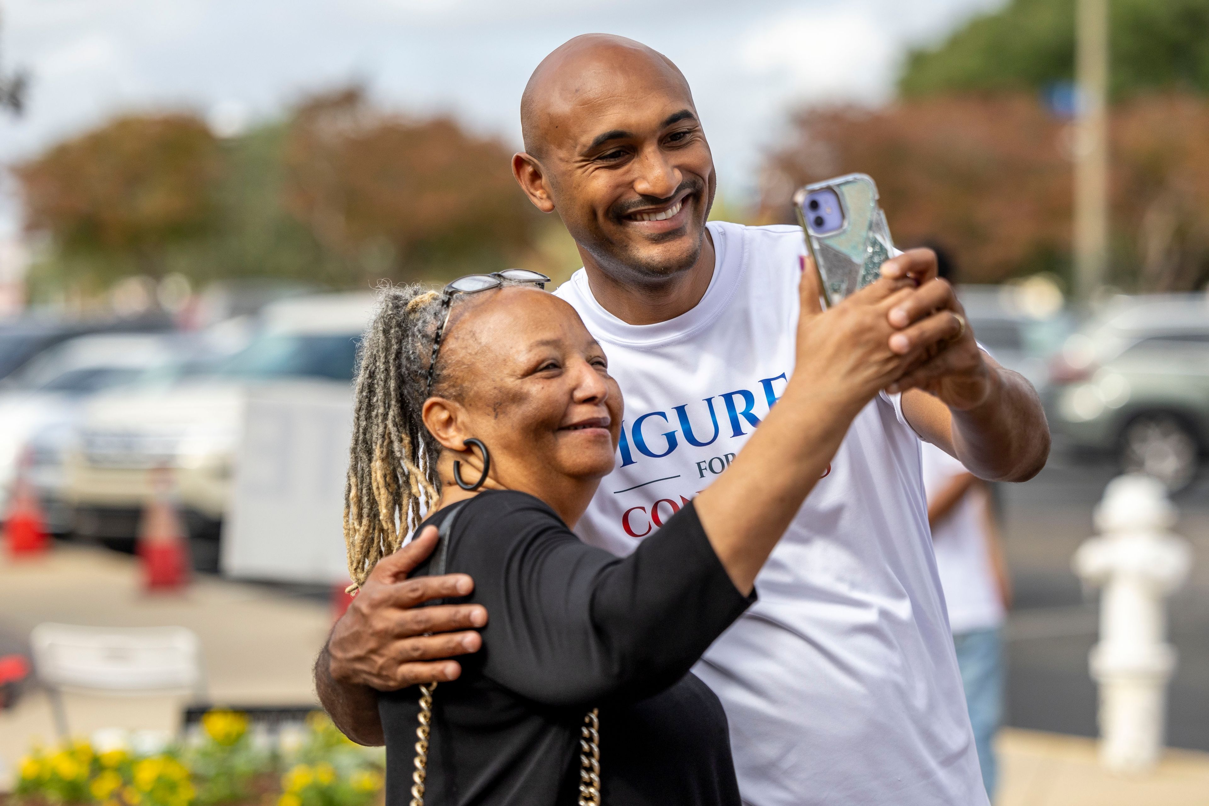 Shomari Figures, Democratic candidate for Alabama's 2nd congressional district, greets and takes a photo with Abbie Felder, of Montgomery, at the Frazer Church voting precinct, on Election Day, Tuesday, Nov. 5, 2024, in Montgomery, Ala. (AP Photo/Vasha Hunt)