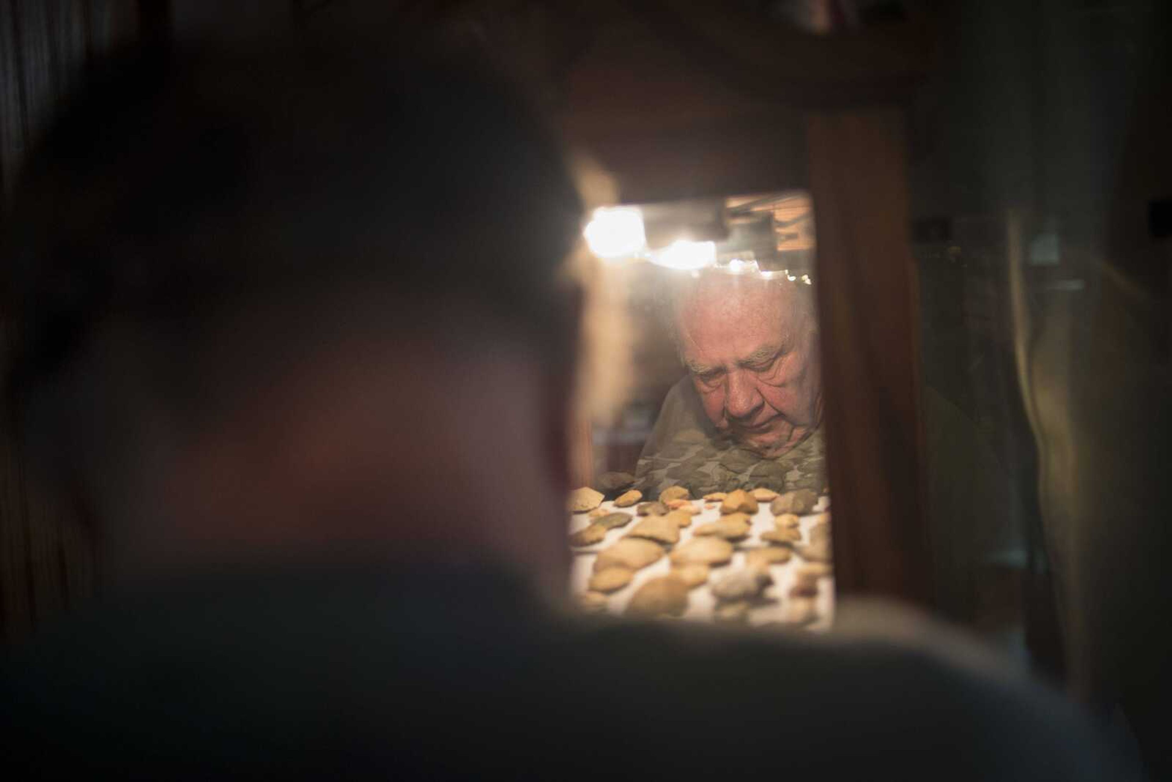 Emmett "Butch" Bounds looks at his arrowhead collection Thursday, Nov. 16, in Cape Girardeau.