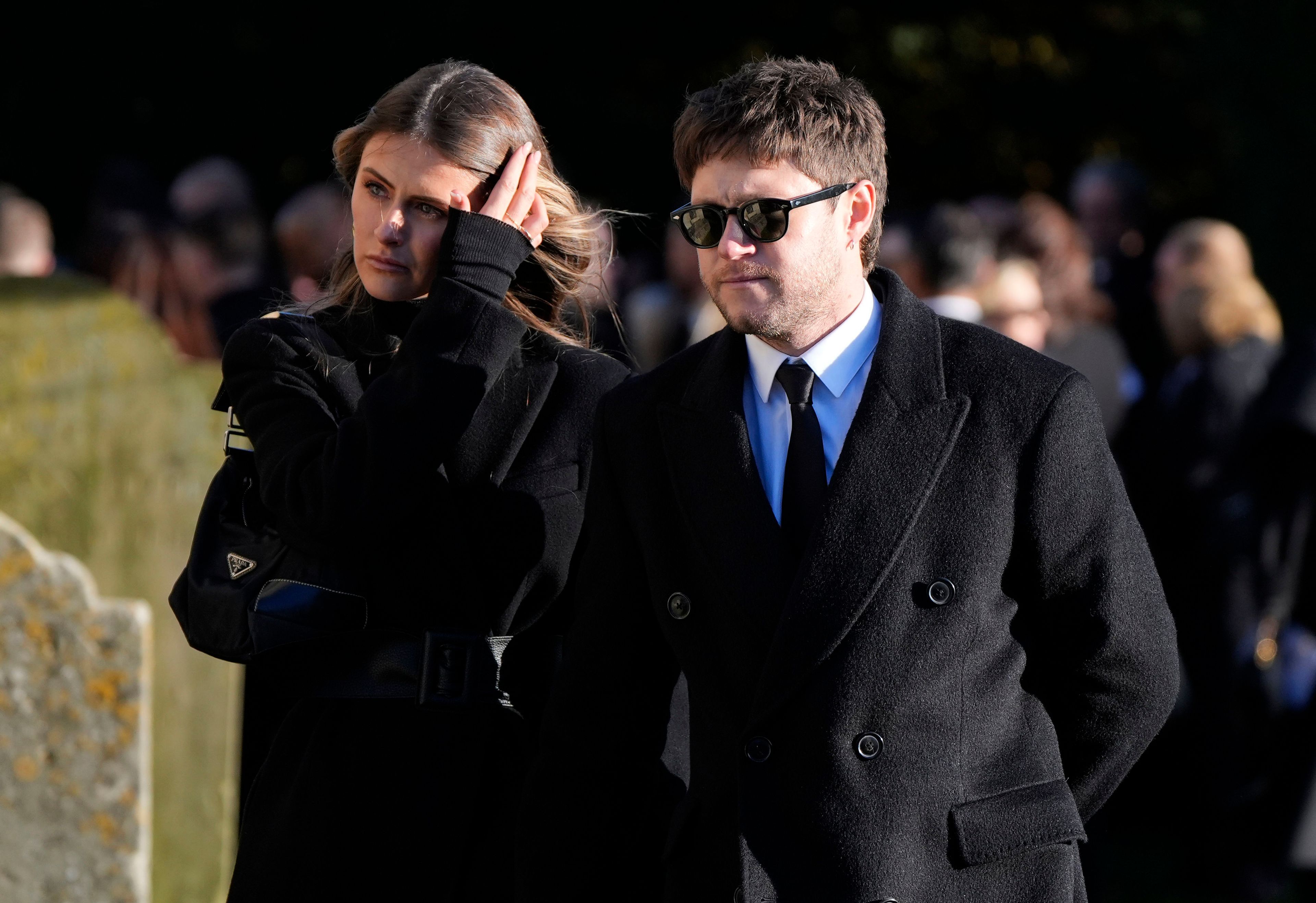 Niall Horan, right, walks after the funeral service for One Direction singer Liam Payne at St Mary's Church in Amersham, England, Wednesday, Nov. 20, 2024. (Andrew Matthews/PA via AP)