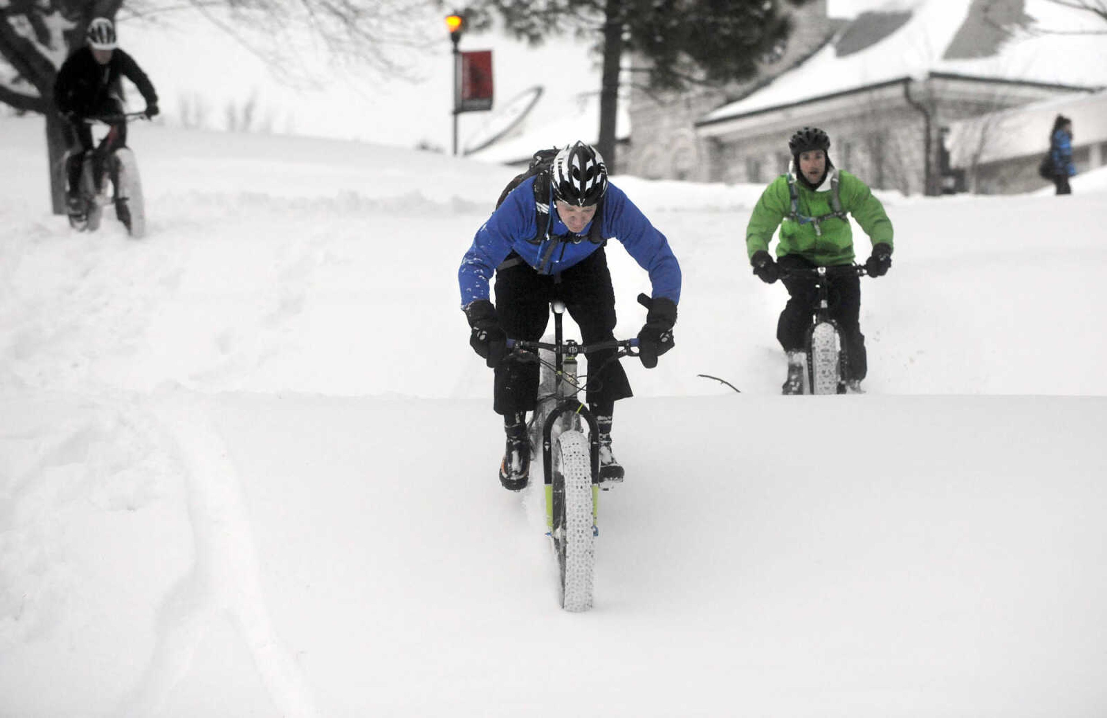 LAURA SIMON ~ lsimon@semissourian.com

Bob Berck, left, John Dodd, center, and Tim Vollink ride fat bikes through the snow on the terraces outside Academic Hall Tuesday evening, Feb. 17, 2015.