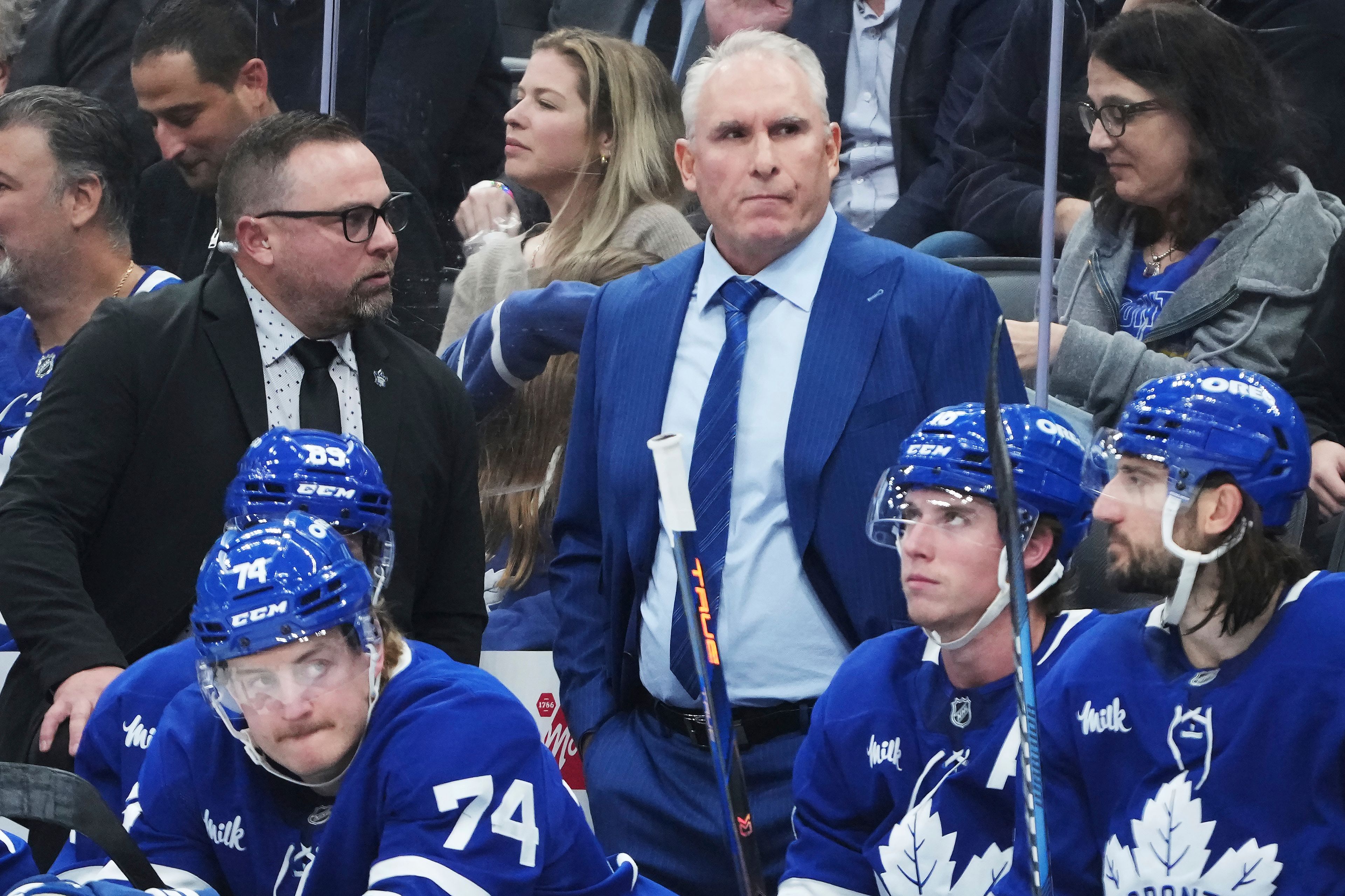 Toronto Maple Leafs head coach Craig Berube, center top, stands on the bench during third-period NHL hockey game action against the St. Louis Blues in Toronto, Thursday, Oct. 24, 2024. (Nathan Denette/The Canadian Press via AP)