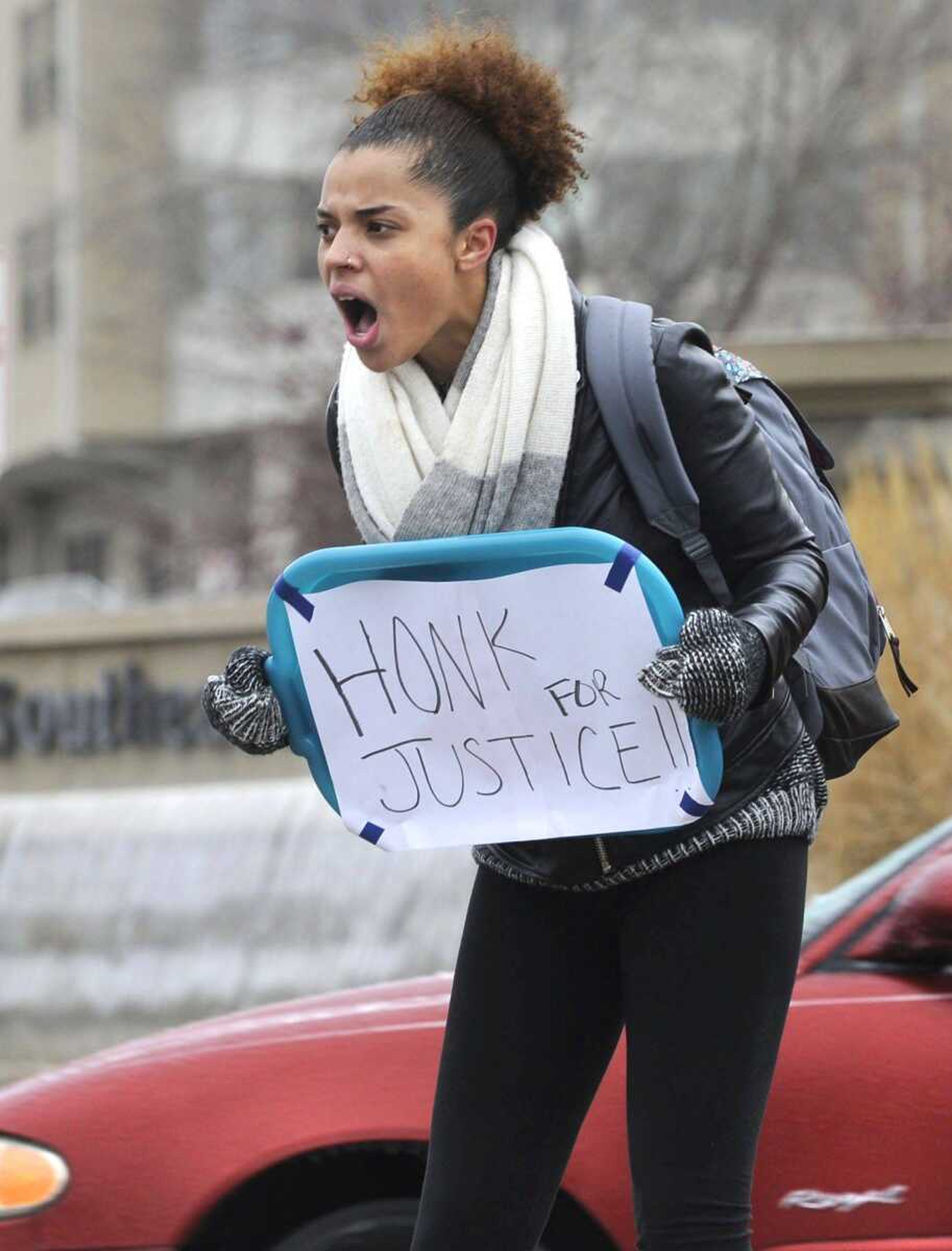 Nile McClain, a junior at Southeast Missouri State University from St. Louis, shouts slogans with a small group protesting recent events in Ferguson, Missouri on Monday, Dec. 1, 2014 at Henderson Avenue and Broadway in Cape Girardeau. (Fred Lynch)