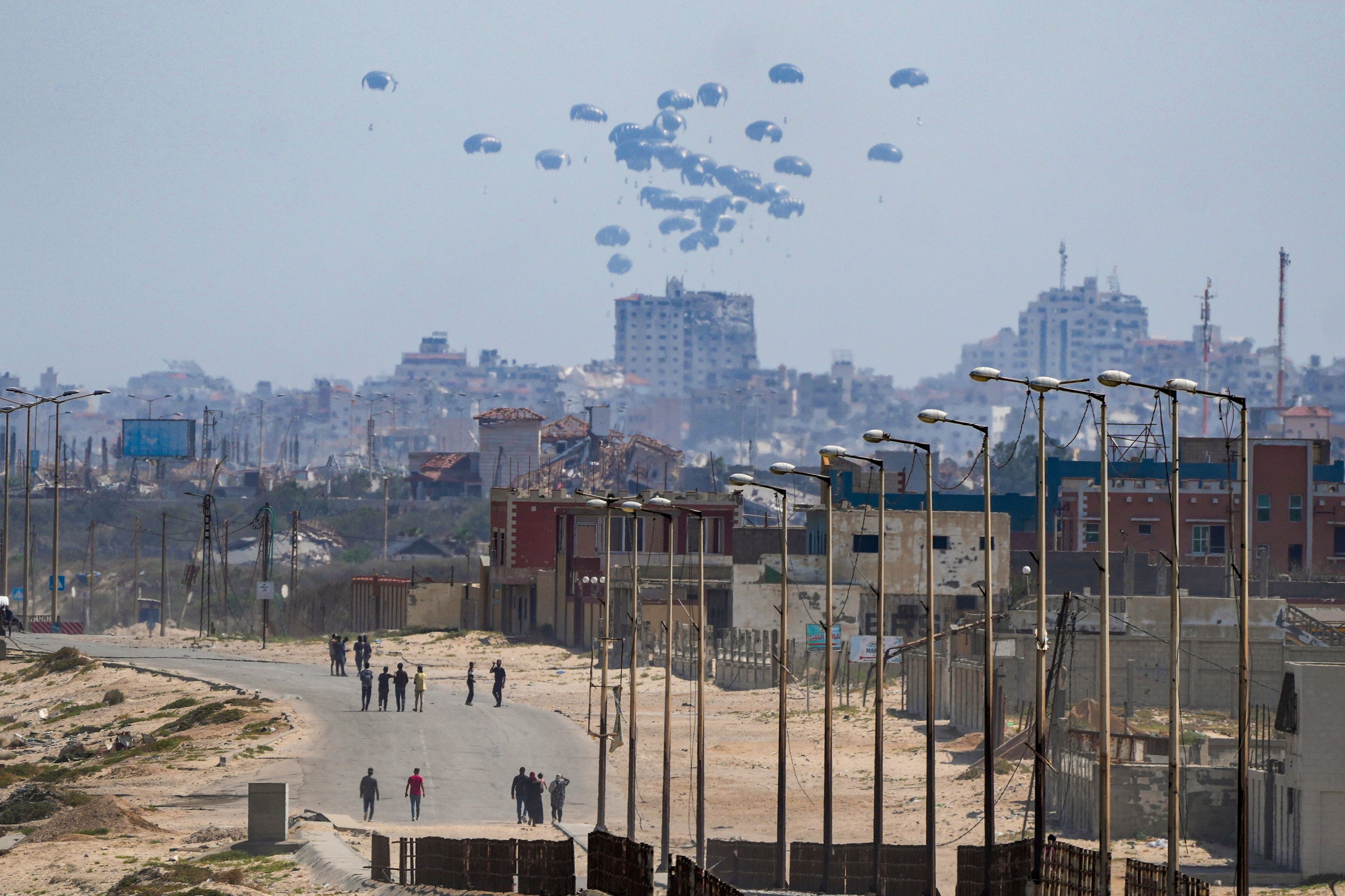 FILE - An aircraft airdrops humanitarian aid over the northern Gaza Strip, as seen from central Gaza, Tuesday, April 30, 2024. (AP Photo/Abdel Kareem Hana, File)