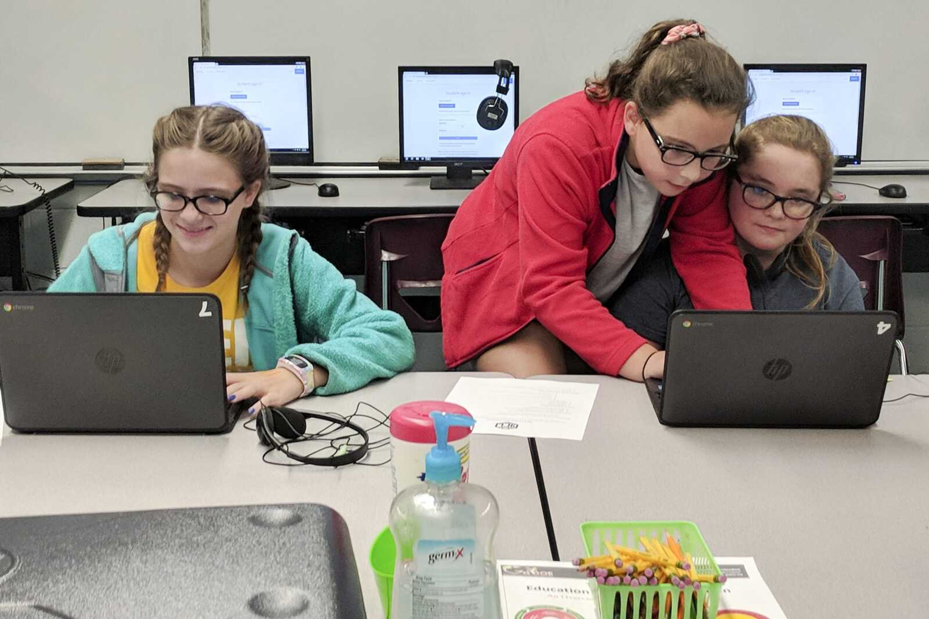 Youth Coding League players assemble code on laptops Sept. 25.