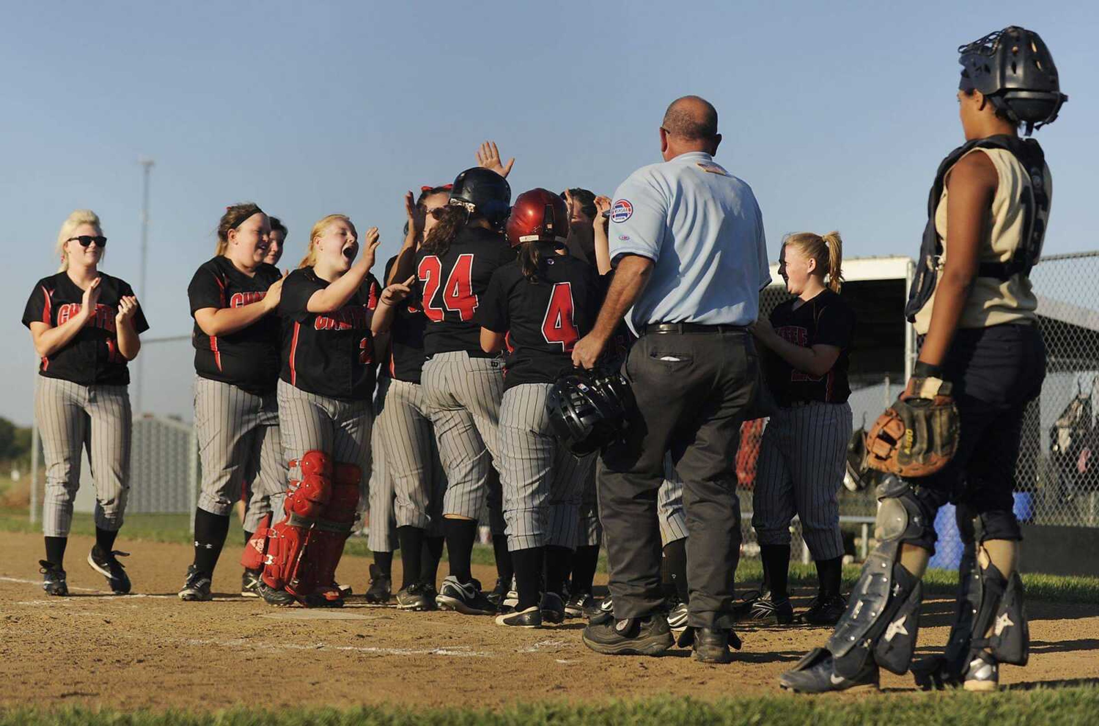 Chaffee&#8217;s Cierra Crites (24) is mobbed by teammates after hitting a grand slam during the Red Devils&#8217; 14-9 win over the Crusaders on Tuesday at Saxony Lutheran High School. (ADAM VOGLER)