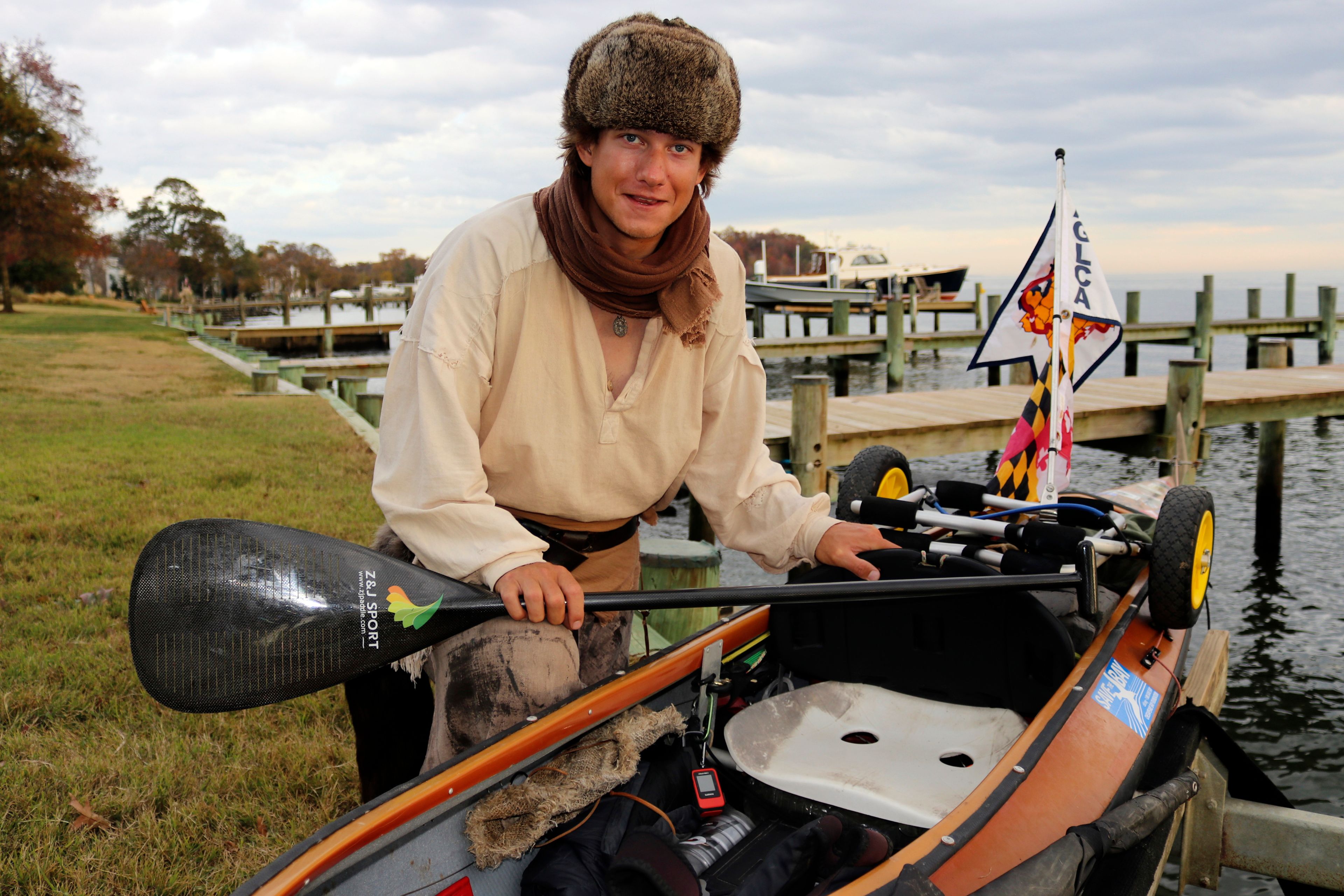 Peter Frank, who is attempting to make a roughly 6,000-mile trip in his canoe to complete the Great Loop, poses by his canoe Thursday, Nov. 7, 2024, in Annapolis, Md. (AP Photo/Brian Witte)