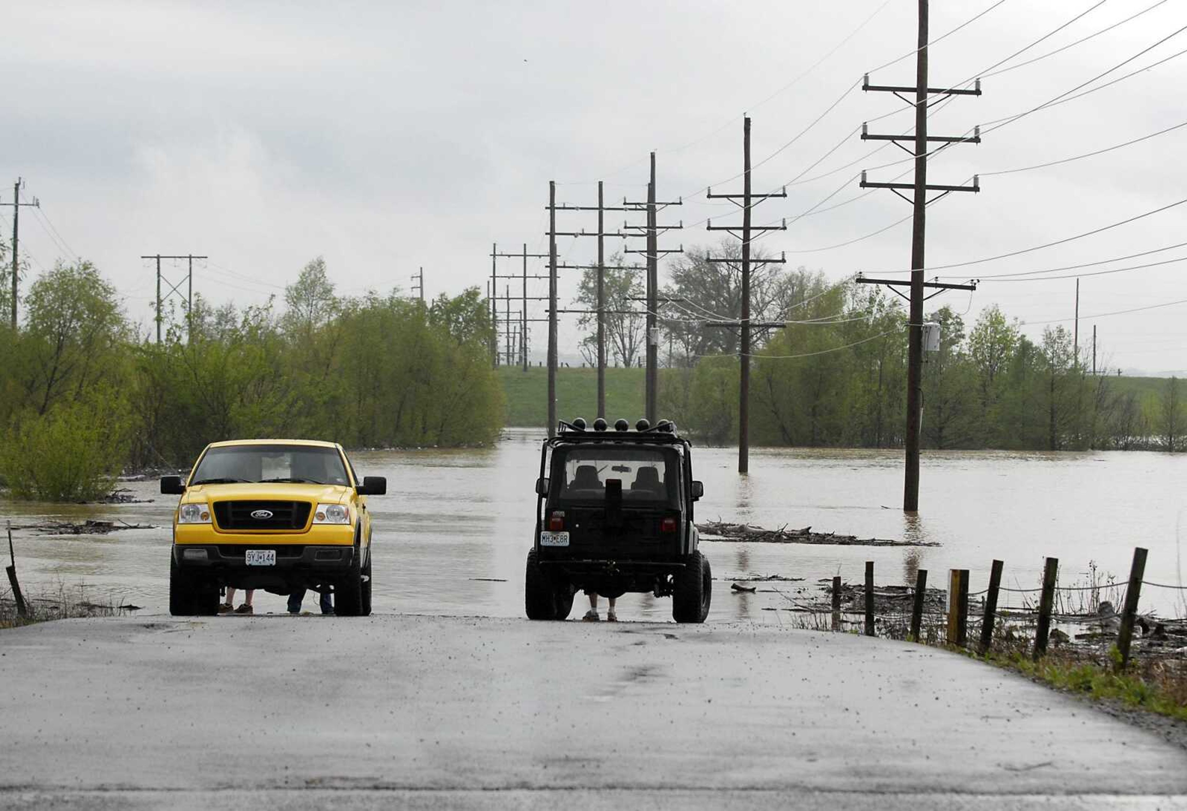 People park their cars to go fishing in the floodwaters Sunday near the Diversion Channel in Cape Girardeau. (Kristin Eberts)