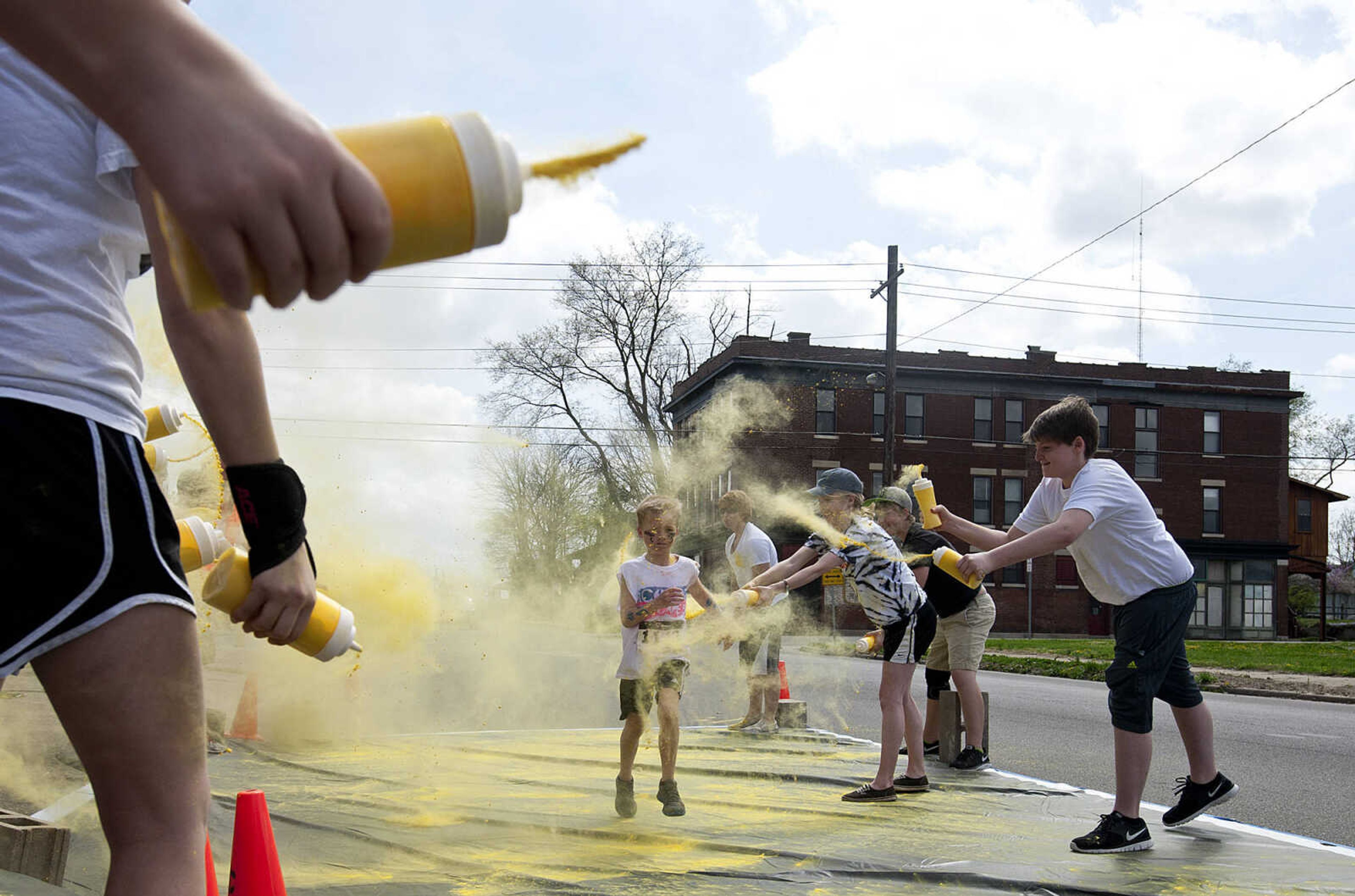 ADAM VOGLER ~ avogler@semissourian.com
Participants in the Color Me Cape 5k run through the yellow color station north of the intersection of Independence Street and Frederick Street Saturday, April 12, in Cape Girardeau.