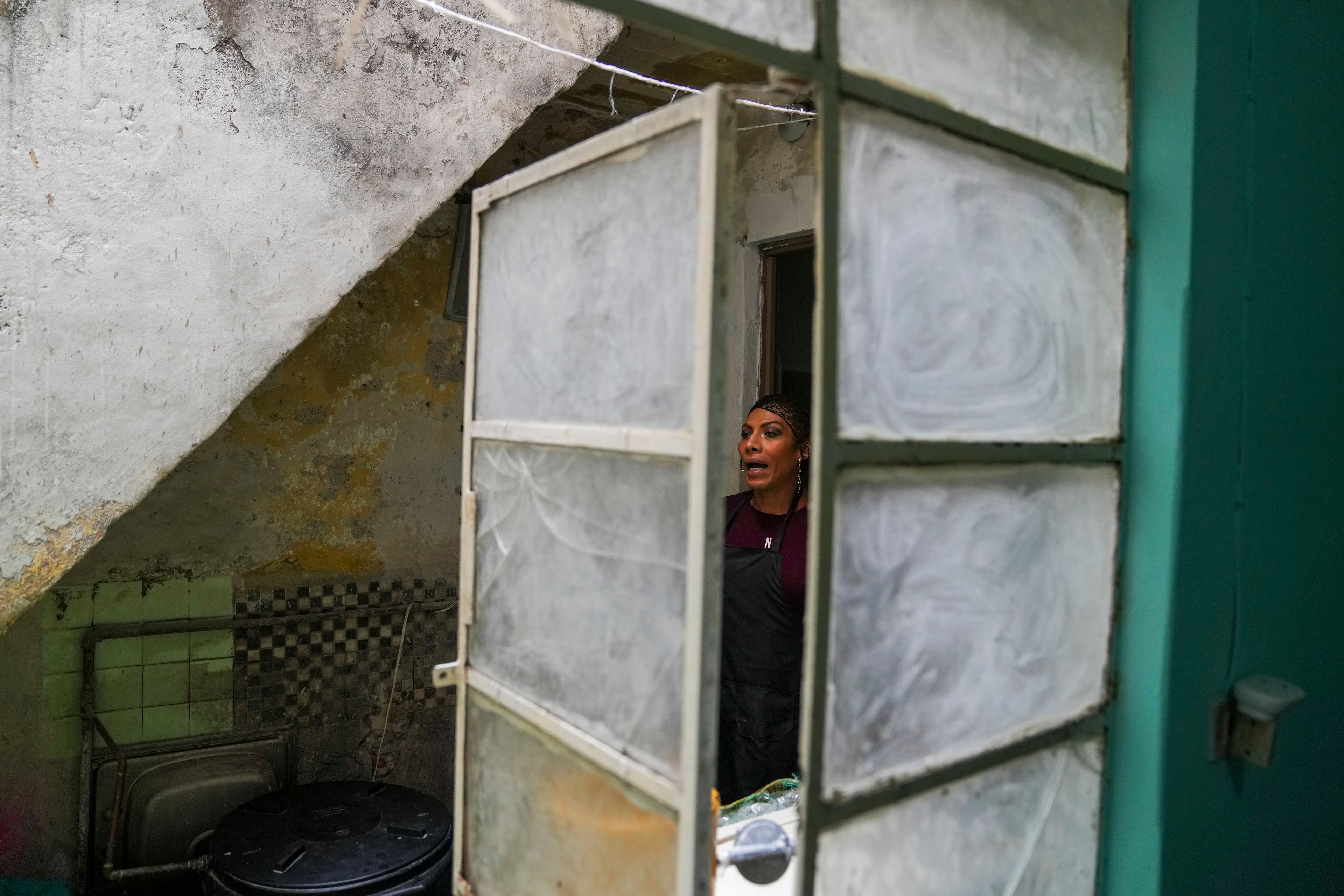 Karolina Long Tain González Rodríguez, a trans woman, gives instructions to Yamileth Adriano, not pictured, before opening the community kitchen at Casa Lleca, an LGBTQ+ shelter in the Peralvillo neighborhood of Mexico City, Friday, Sept. 20, 2024. (AP Photo/Fernando Llano)