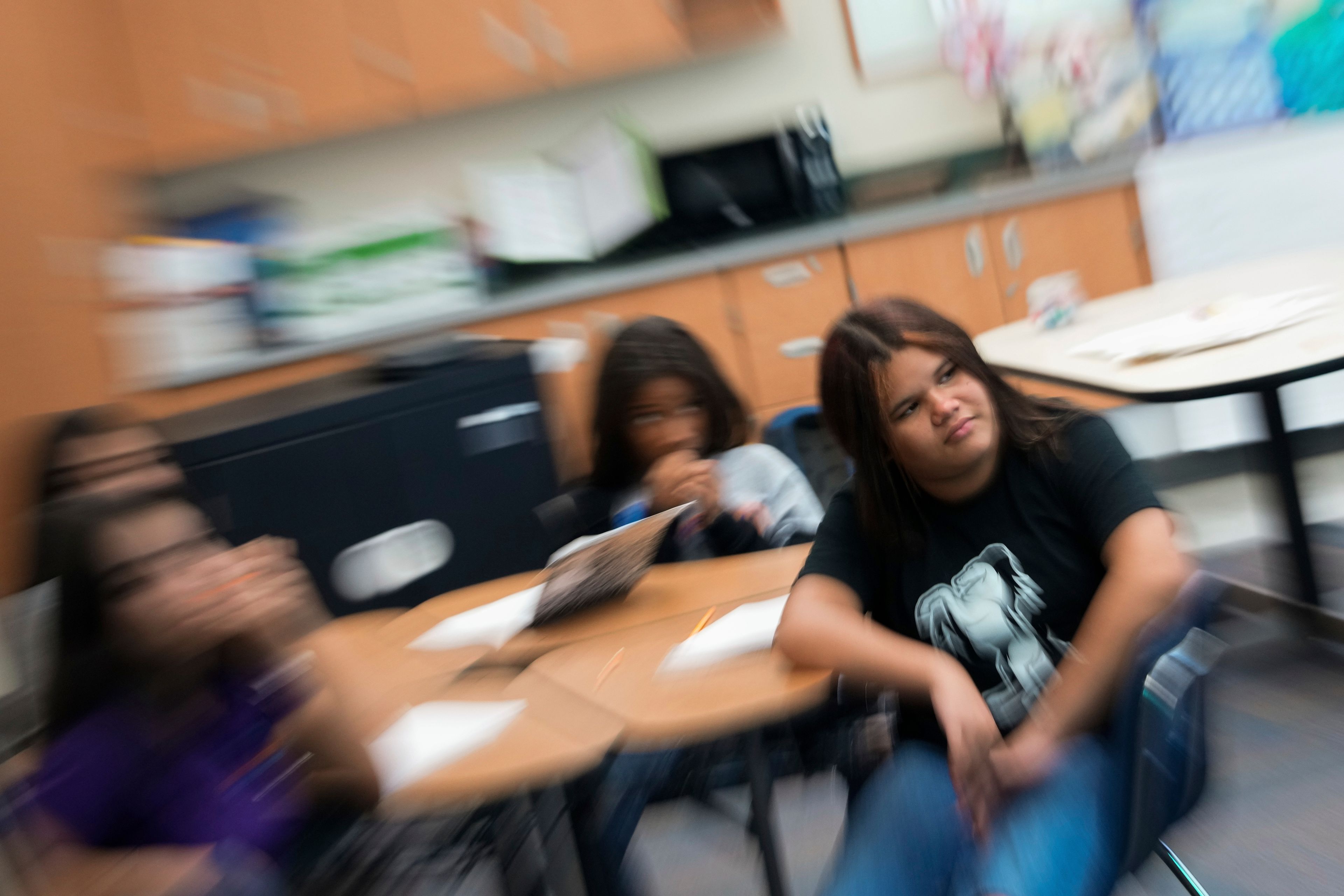 Alisson Ramírez, right, listens to her social studies teacher during class Wednesday, Aug. 28, 2024, in Aurora, Colo. (AP Photo/Godofredo A. Vásquez)