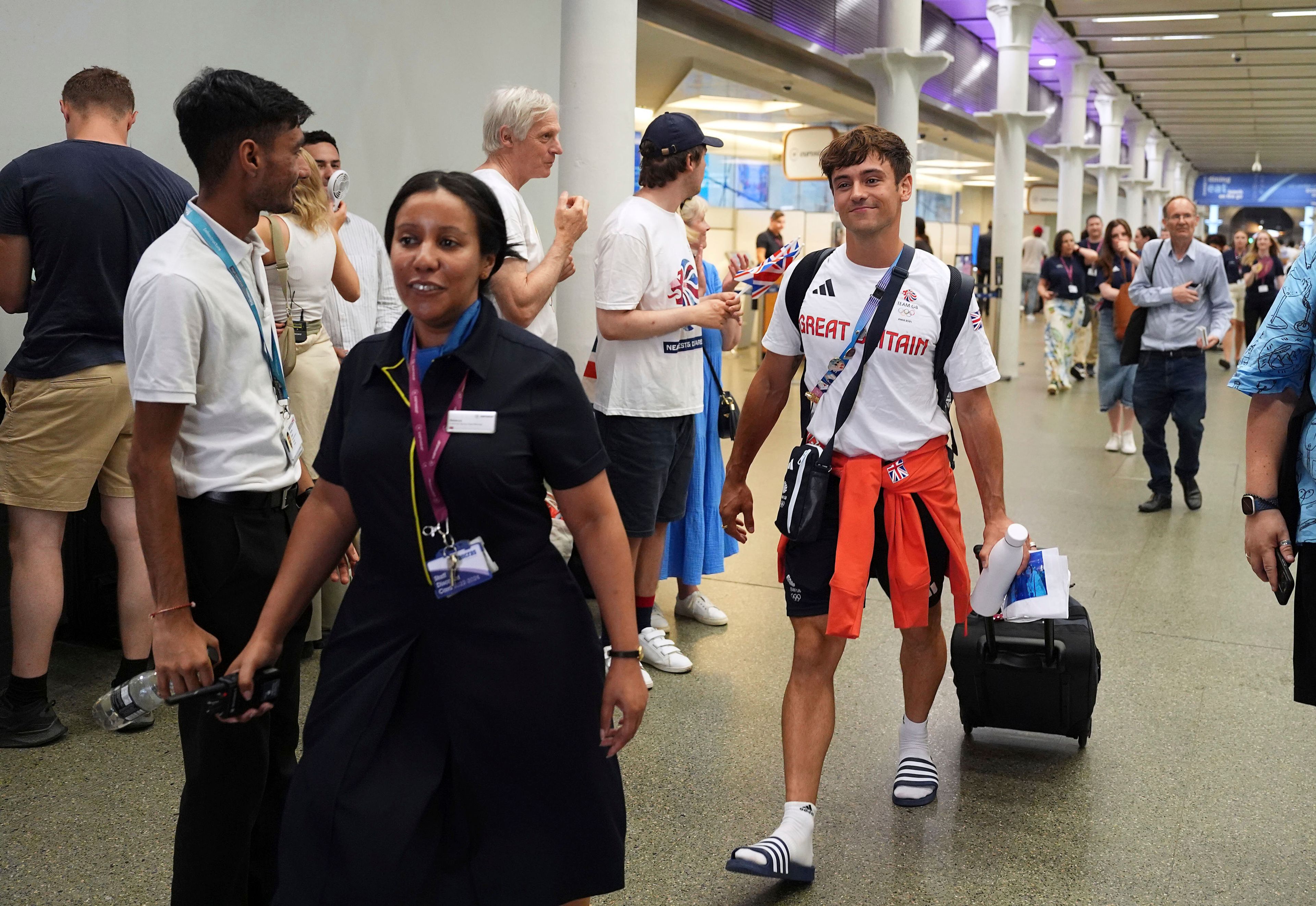 Great Britain's Tom Daley arrives by Eurostar into London St. Pancras International train station after competing at the 2024 Paris Olympic Games in France, Monday Aug. 12, 2024. Five-time Olympic gold medalist Tom Daley has announced his retirement from diving. (Jordan Pettitt/PA via AP)