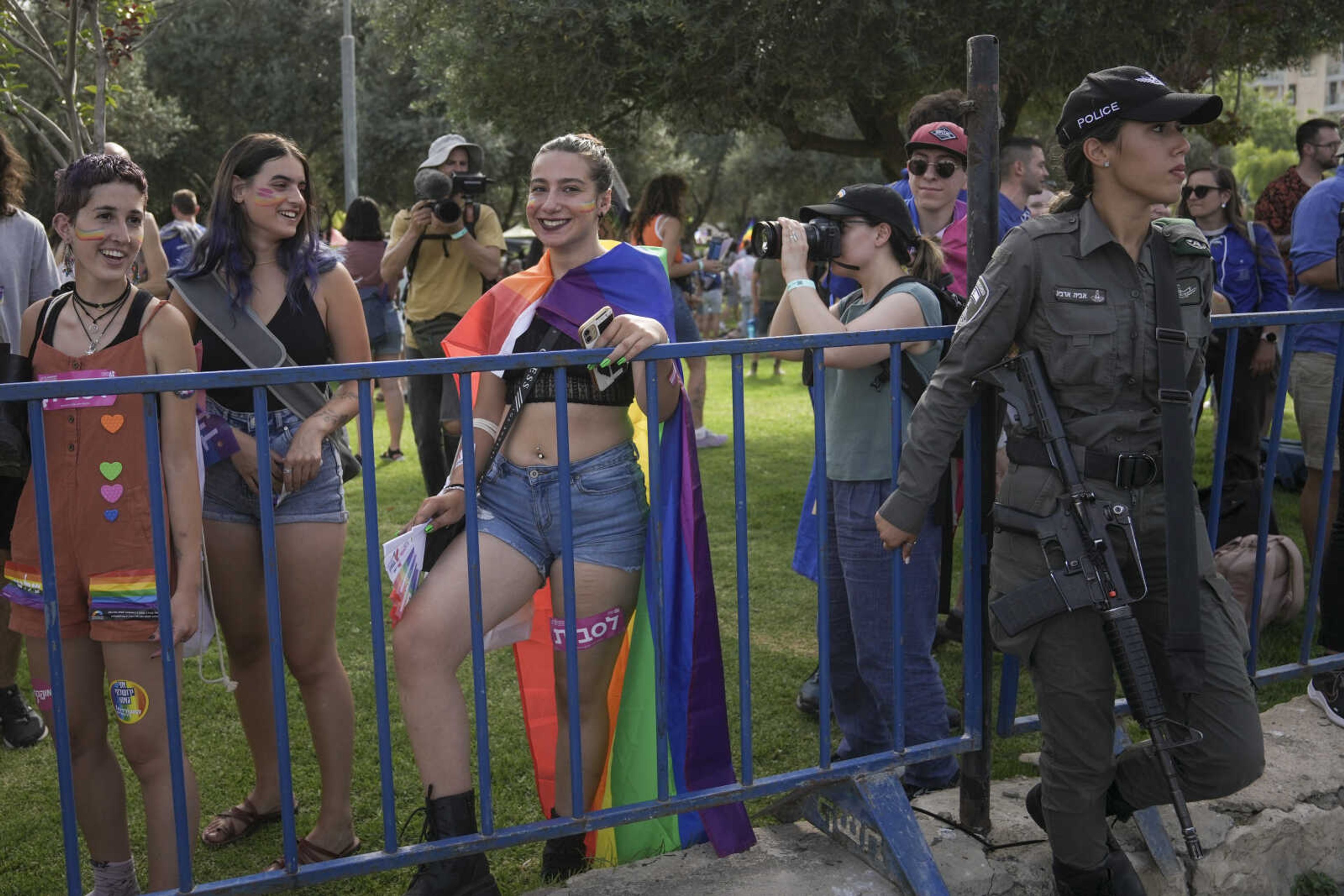 An Israeli border police officer, right, secures the annual Pride parade Thursday in Jerusalem.