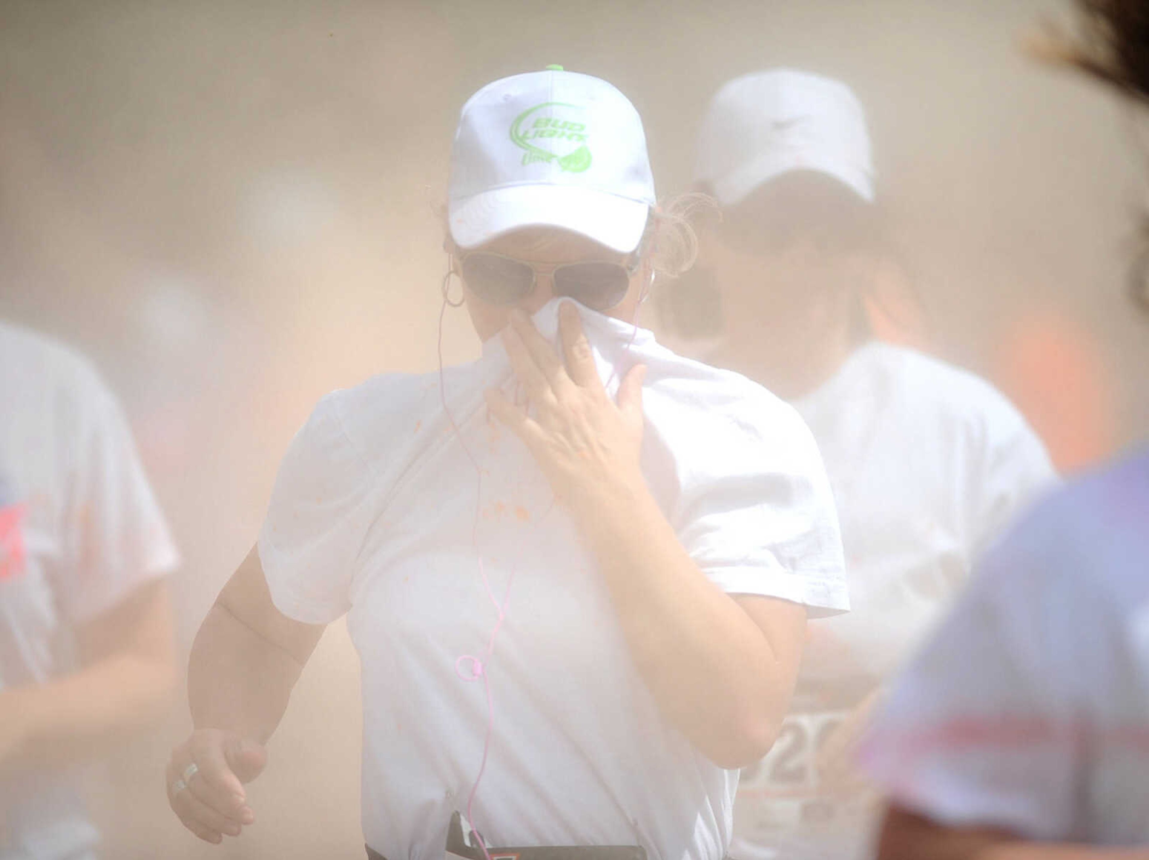 LAURA SIMON ~ lsimon@semissourian.com

Participants in the Color Me Cape 5K are sprayed with orange powder at the first color station on Good Hope Street, Saturday, April 12, 2014, in Cape Girardeau.