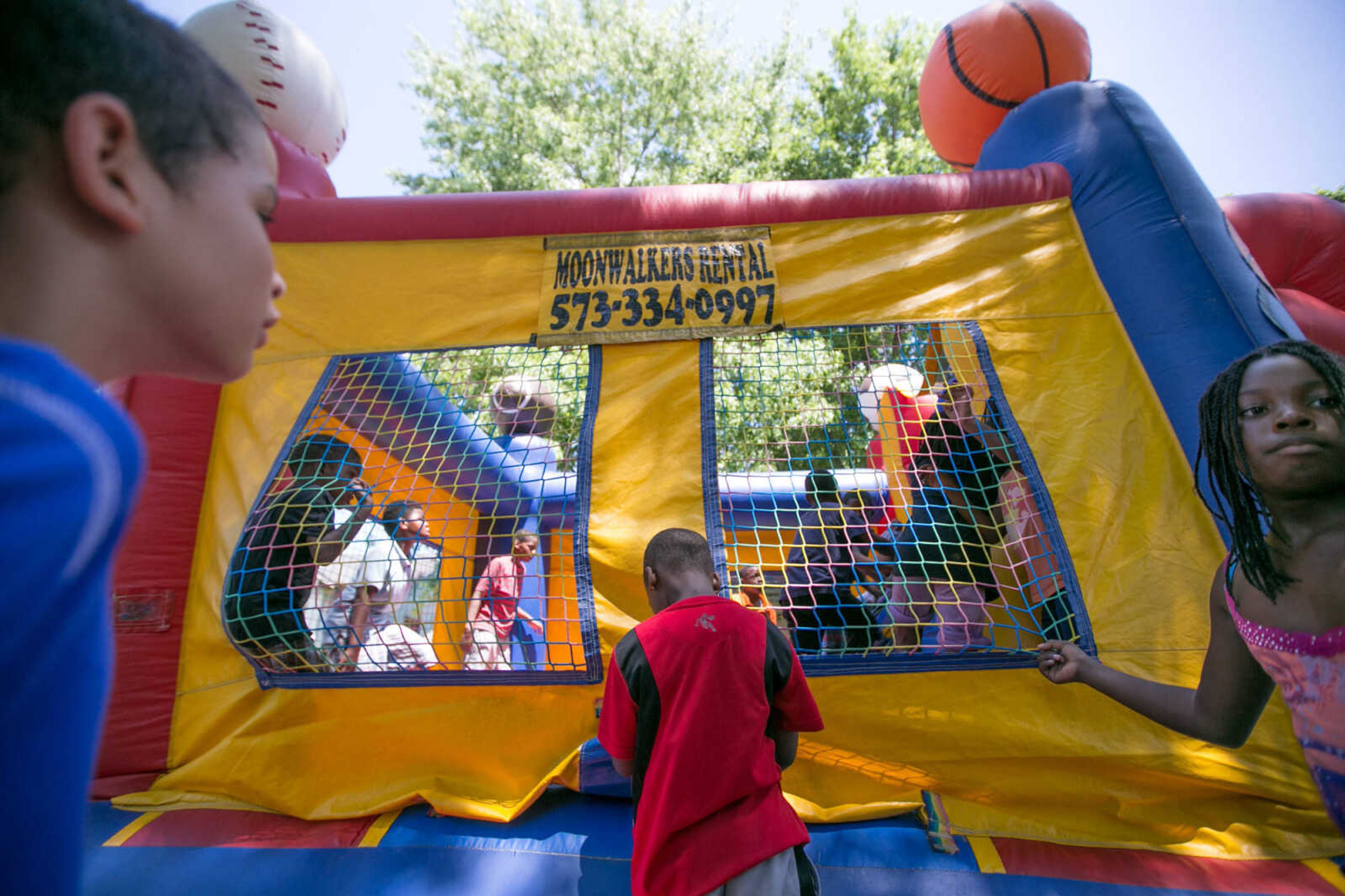 GLENN LANDBERG ~ glandberg@semissourian.com

Kids play around in a bounce house set up during the block party in Cape Girardeau's ward 2 area, Saturday, June 20, 2015.