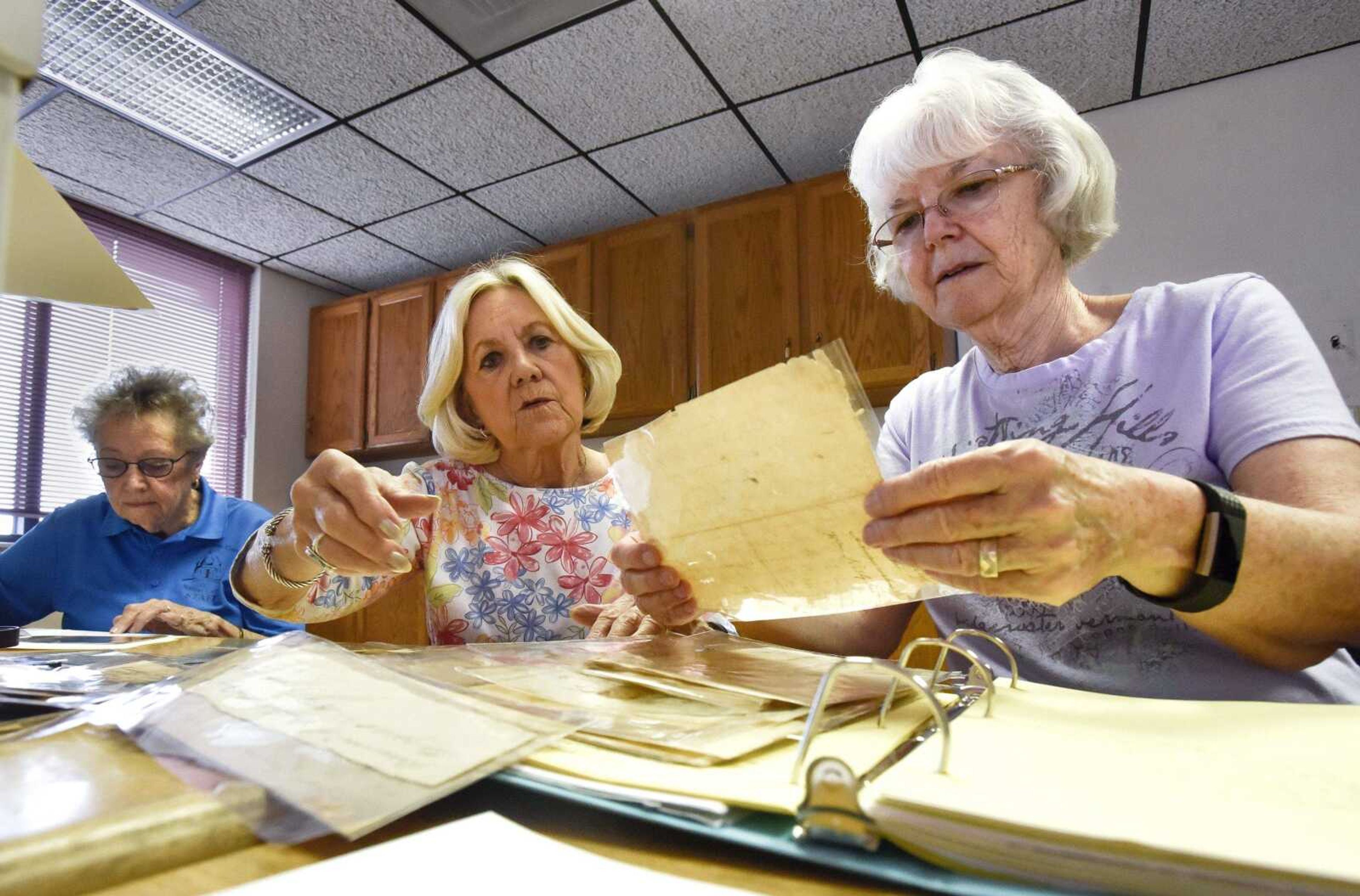 From left, Mary Jo Shelton, Beverly Hahs and Alice Ireland sort through documents Wednesday, June 20, 2018, at Jackson City Hall. The materials donated to the Cape Girardeau County Historical Society include manuscripts and artifacts belonging to Louis Lorimier and his descendants. A planned research annex will make these and other materials accessible to researchers.