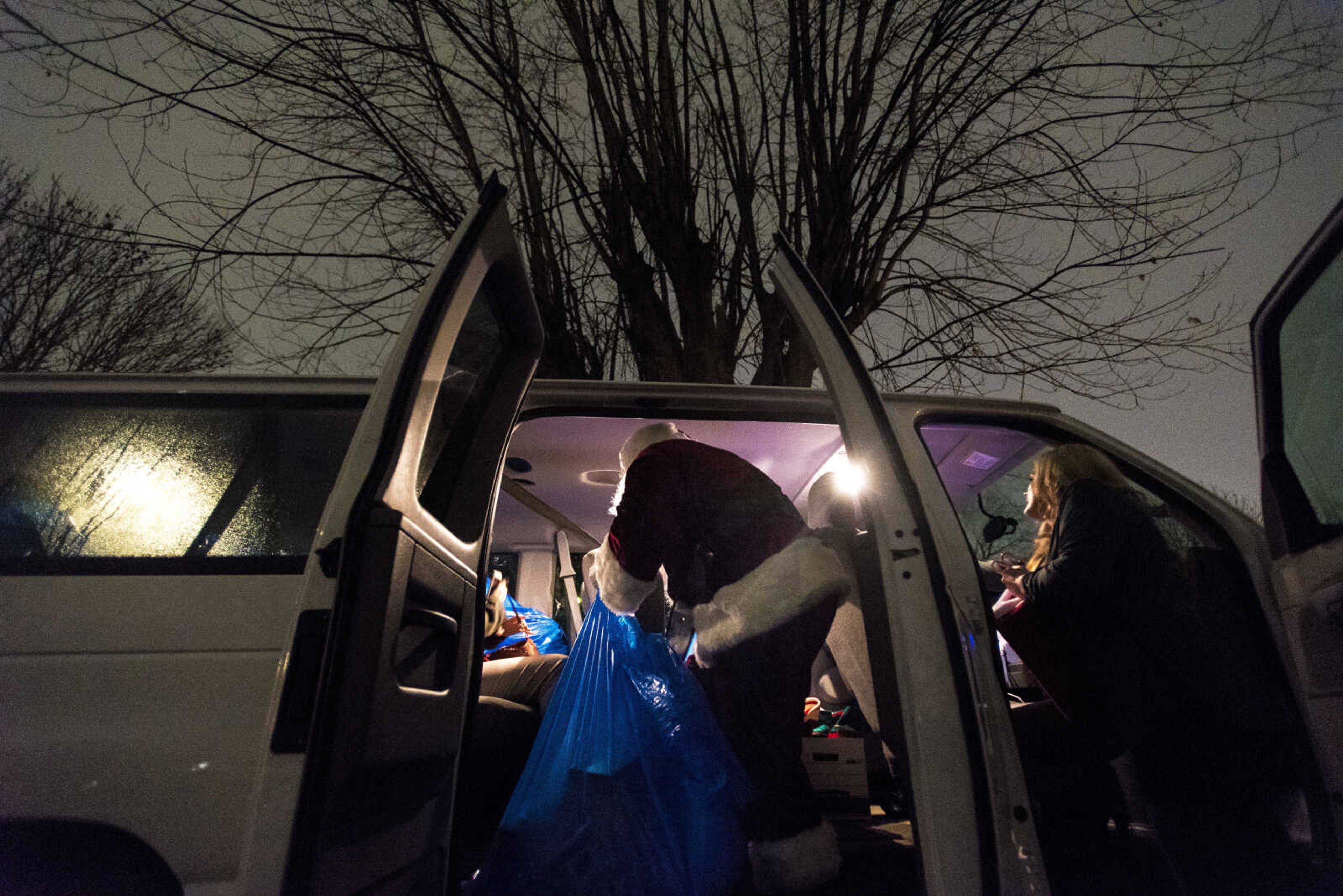 Charlie Wirtle as Santa grabs a sack of presents for kids  during the Jaycee Toybox delivery on Thursday, Dec. 22, 2016, in Cape Girardeau.