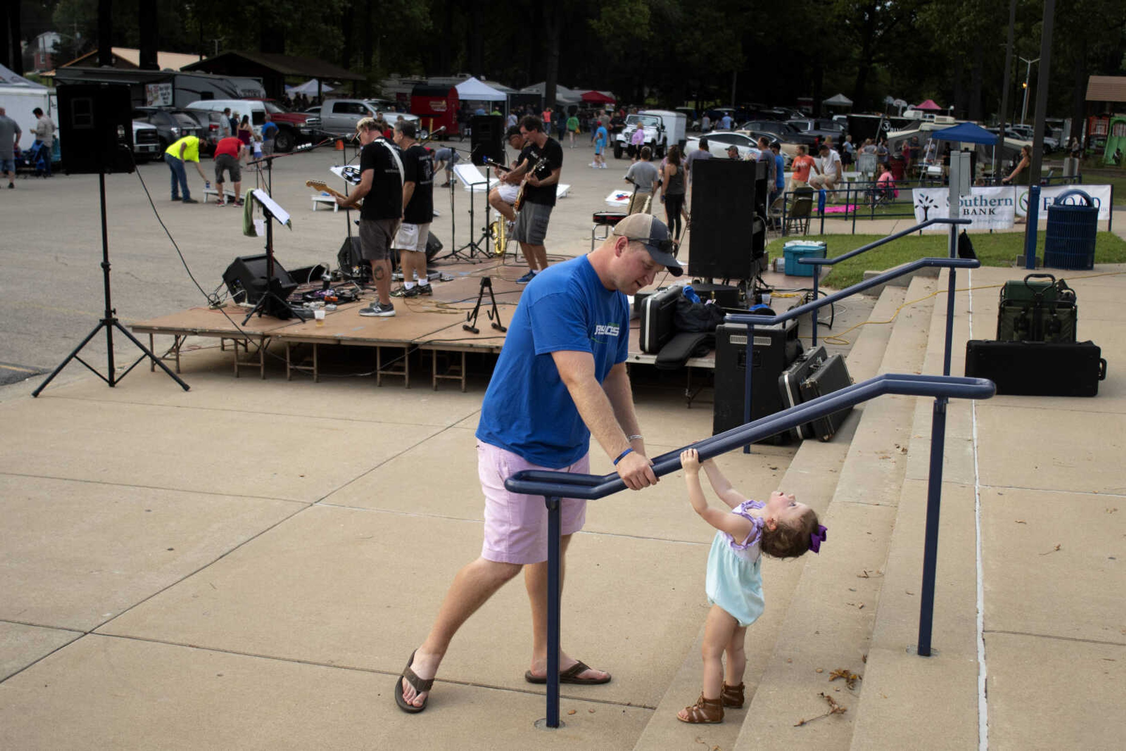 John Oliver of Cape Girardeau plays with Micah Kohlfeld, 1, of Jackson, during the 27th annual Cape Jaycees BBQ Fest on Friday, Aug. 16, 2019, at Arena Park in Cape Girardeau.