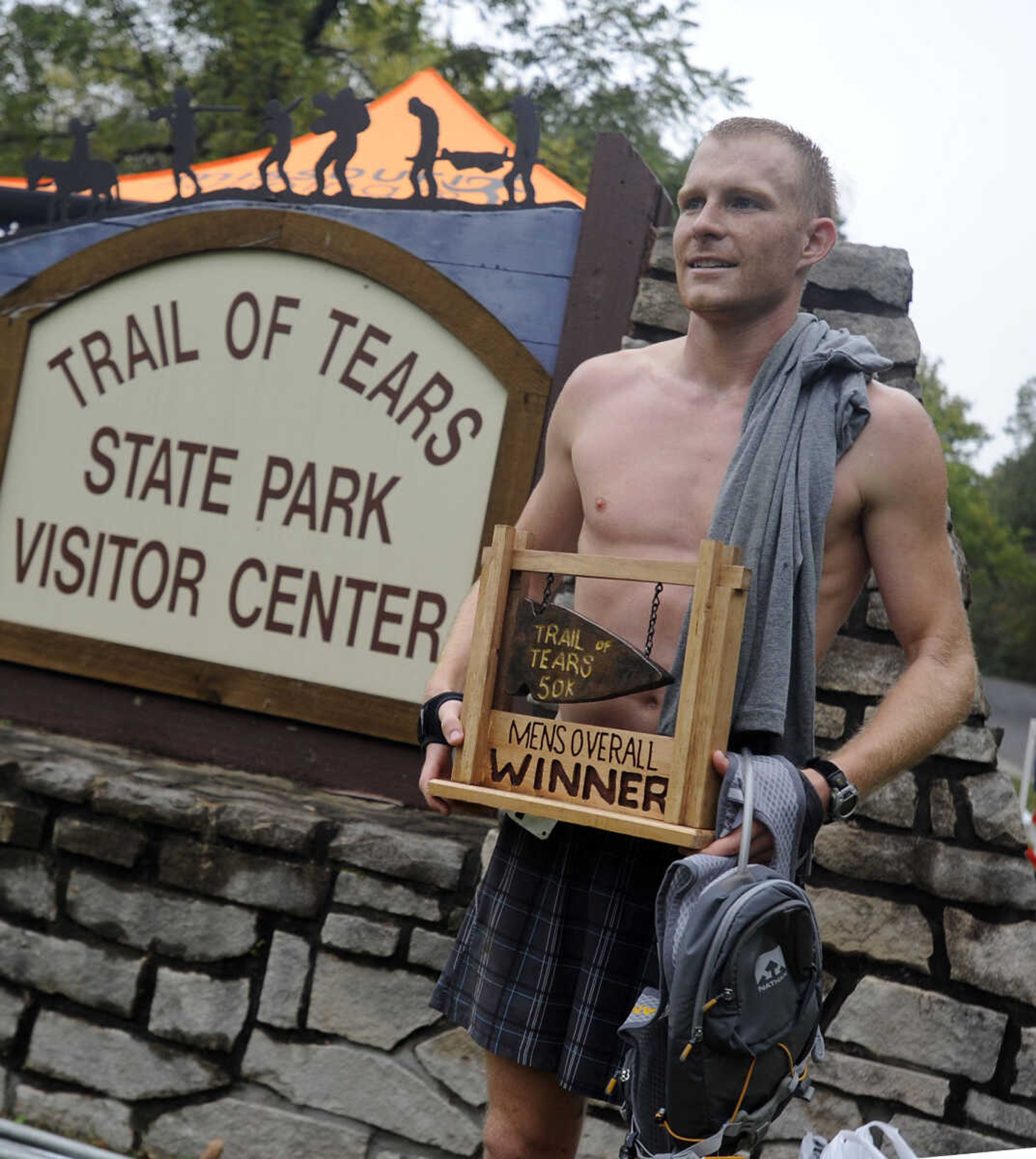 Matt Pfau poses with his first-place trophy in the first Trail of Tears 50k event Sunday, Oct. 12, 2014 at Trail of Tears State Park.