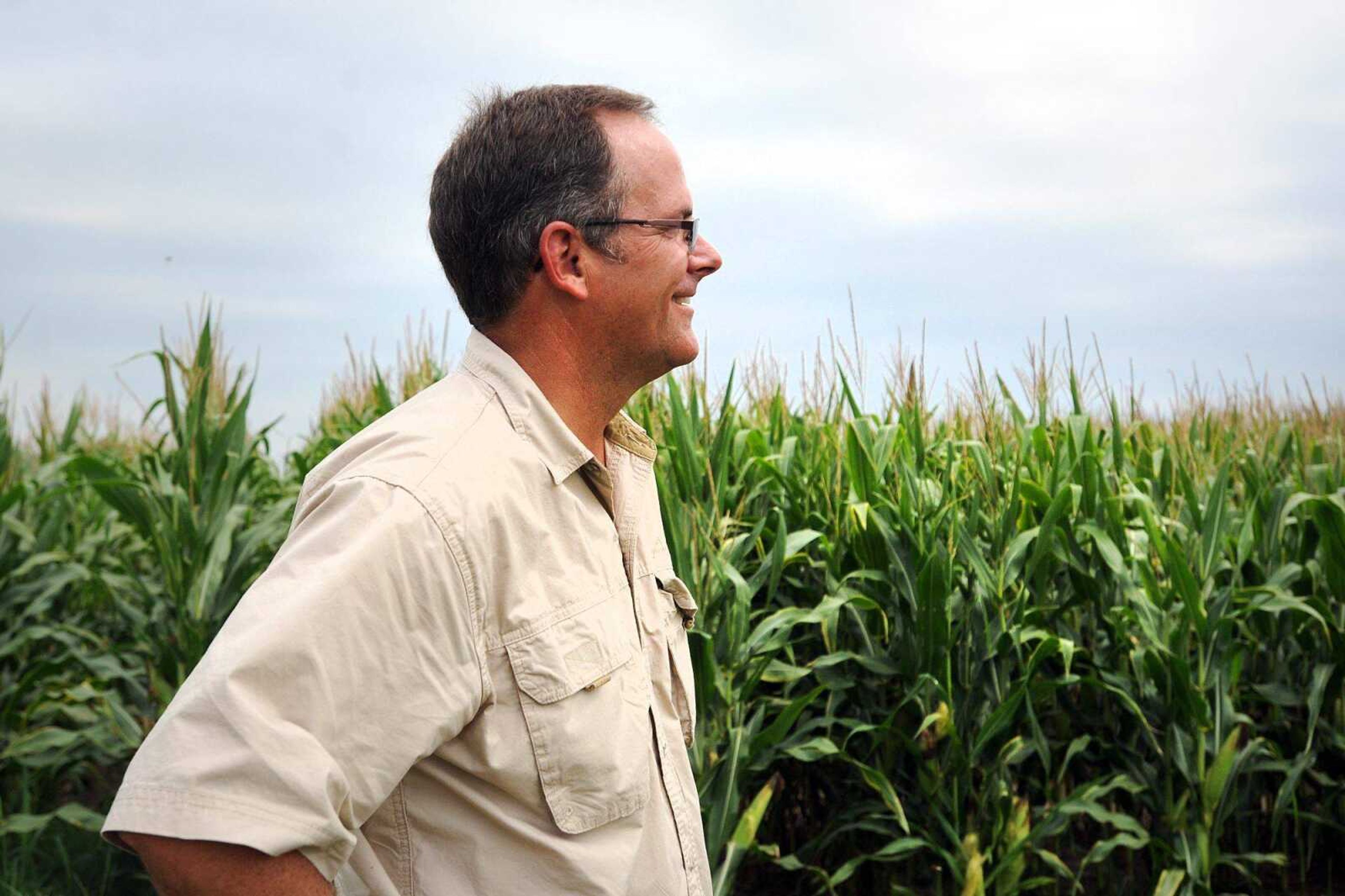 Edward Dement stands alongside a field of corn at Dement Farms on Wednesday in Scott County. (Laura Simon)