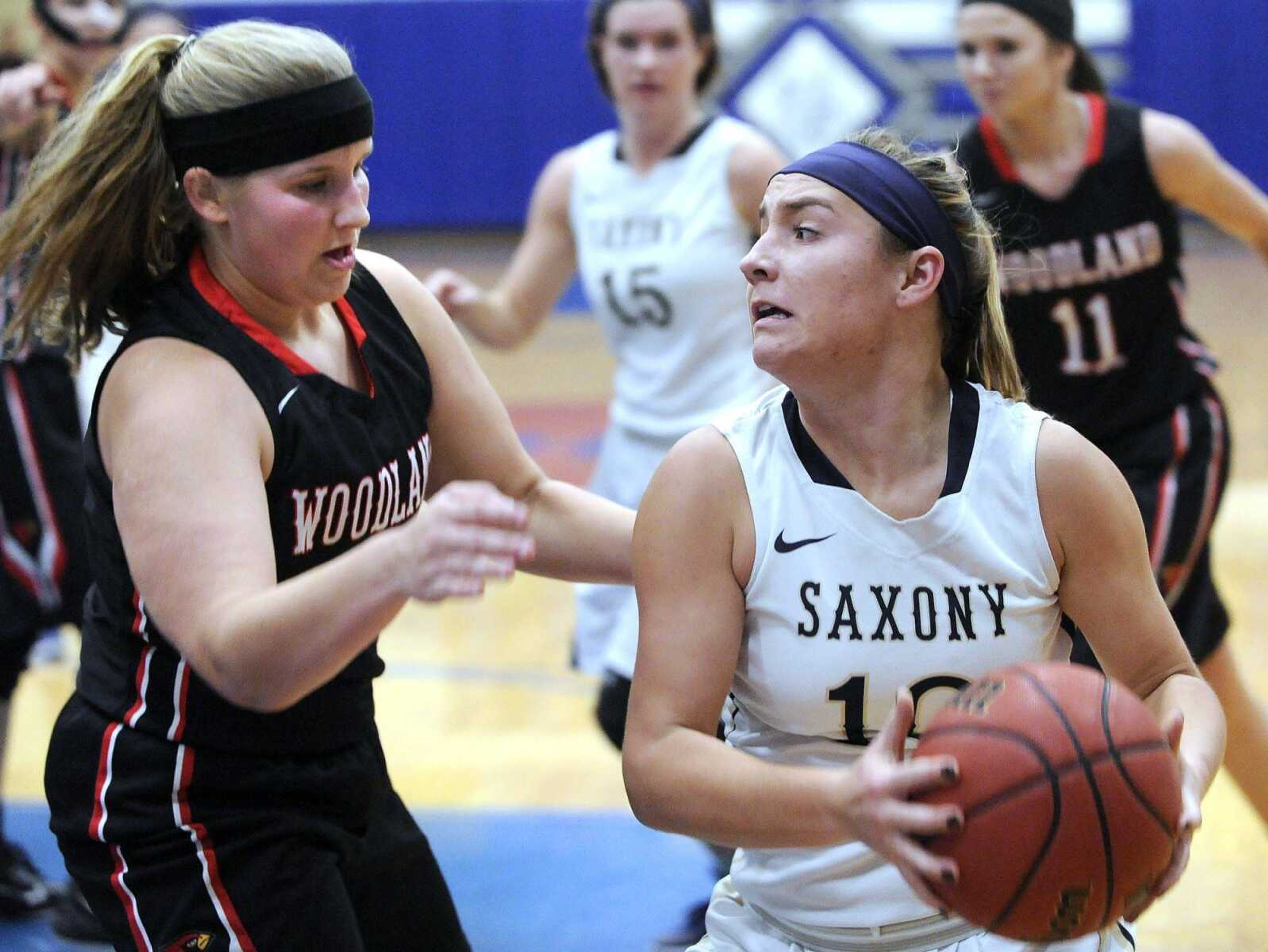 Saxony Lutheran's Grace Mirly drives against Woodland's Mara Grindstaff during the second quarter of a semifinal game in the Delta New Year's Tournament Tuesday, Jan. 5, 2016 in Delta, Missouri. (Fred Lynch)